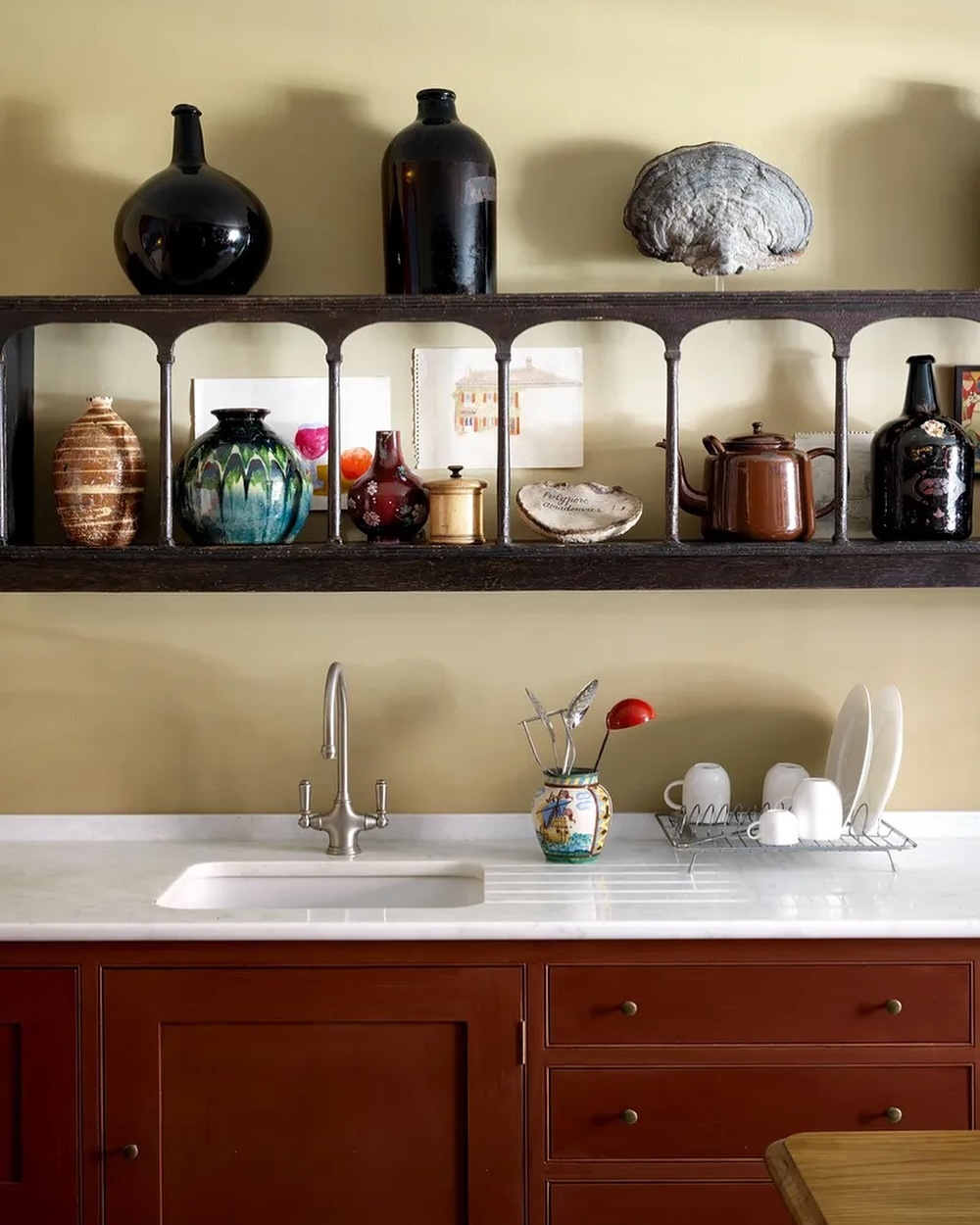 14. Sleek Chrome Faucet with Geometric Glass Shelves Reflecting Light