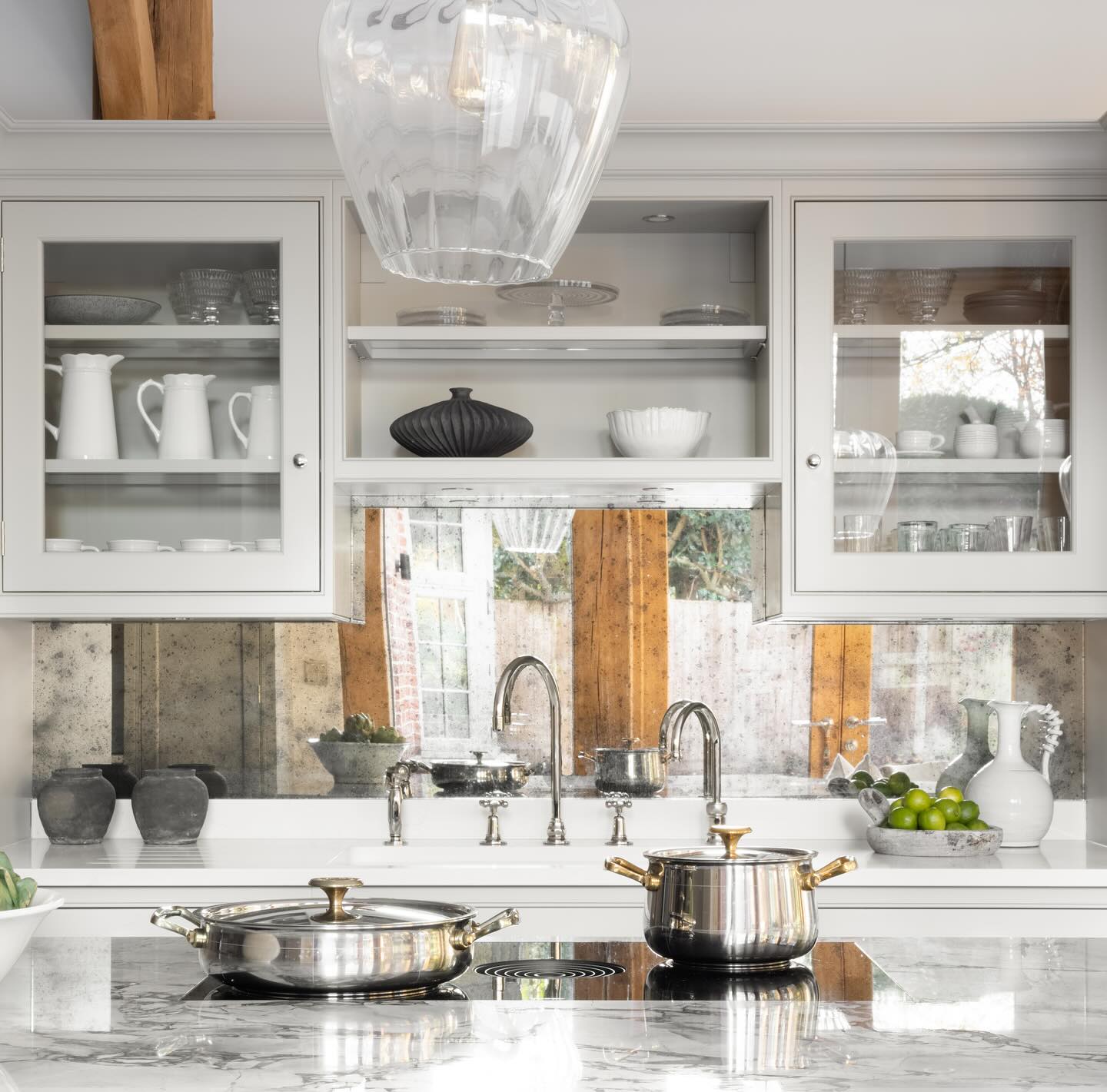 7. Tangled Vines Of Copper Piping Frame a Rustic Wooden Shelf Above a Farmhouse Sink