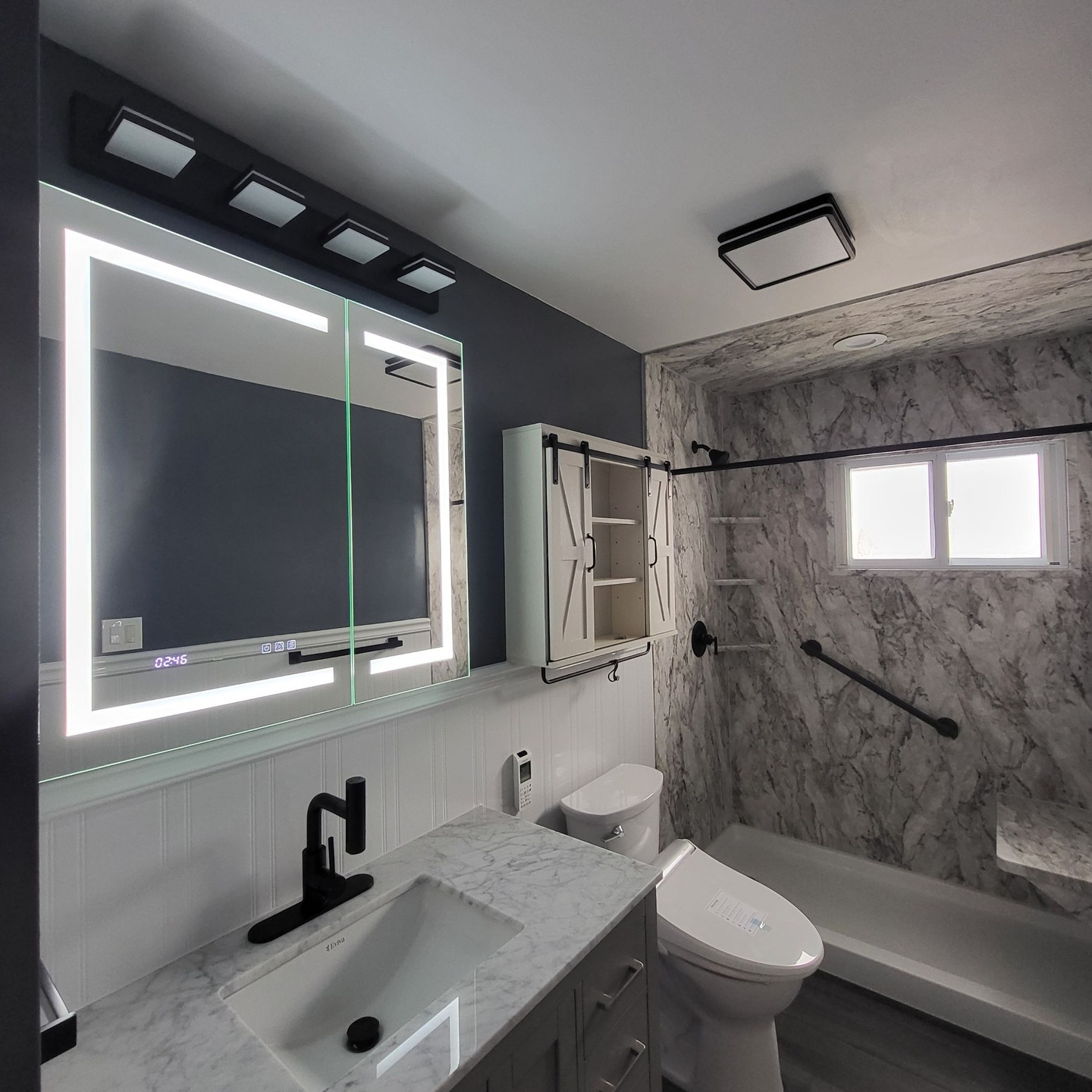 8. Midnight Blue Mosaic Tiles Meet Industrial Piping In Budget-friendly Bath Bliss