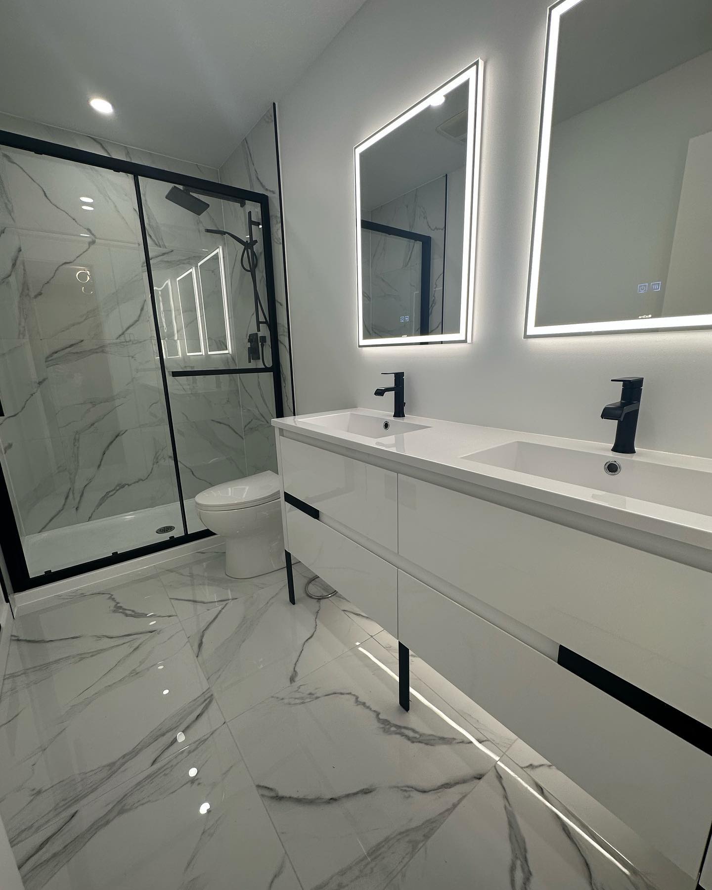 27. Black and White Mosaic Tiles Cascade Over a Floating Sink In a Minimalist Haven