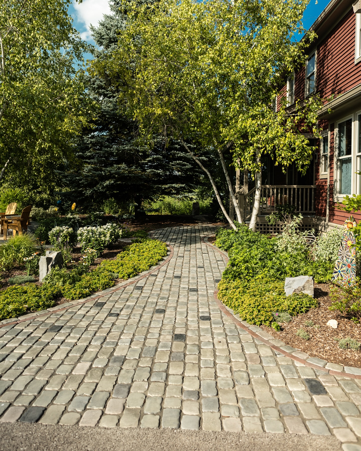 32. Serpentine Stone Pathway with Lush Overhangs and Rustic Bench