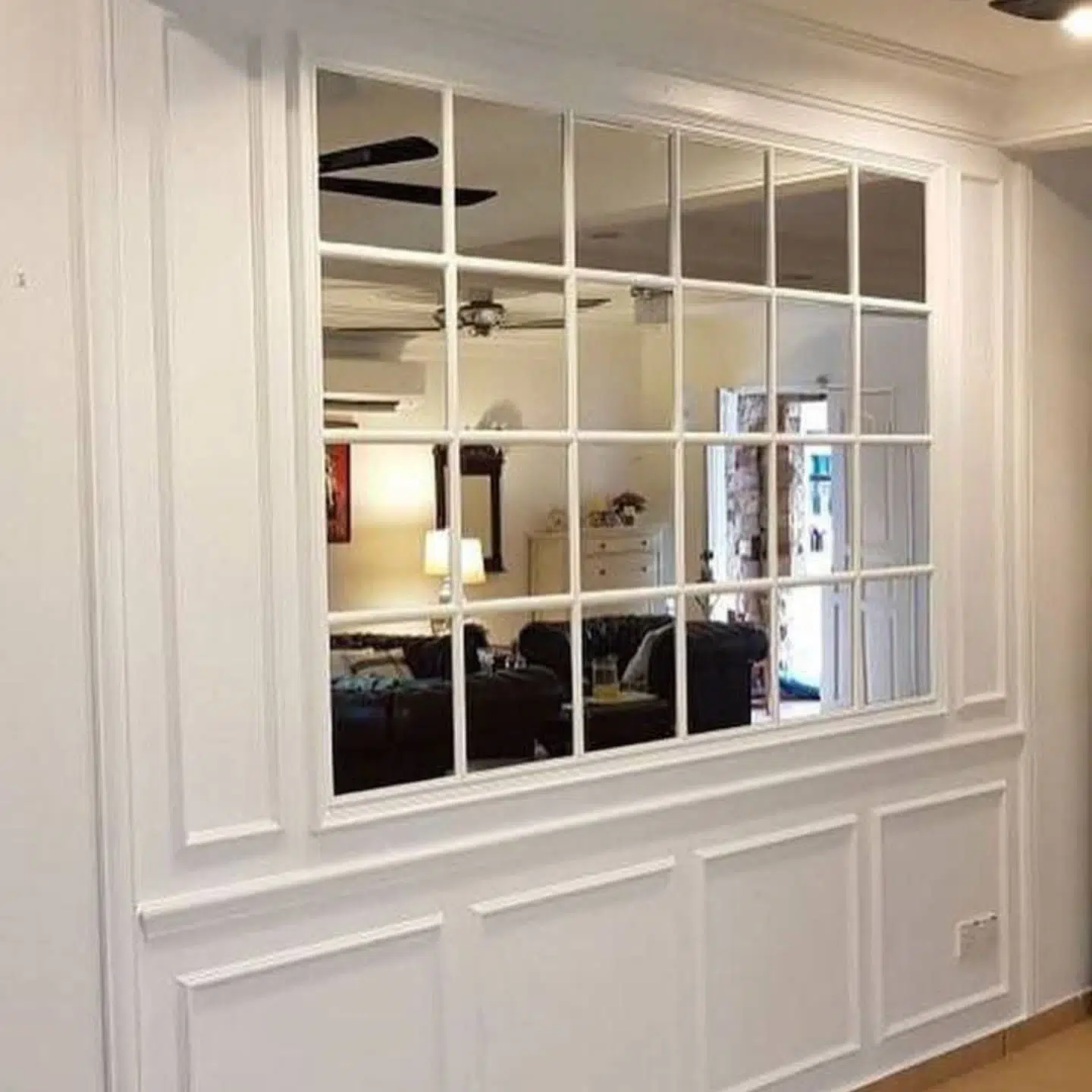 17. Intricate Brass Filigree Mirror Amidst Minimalist White Frames