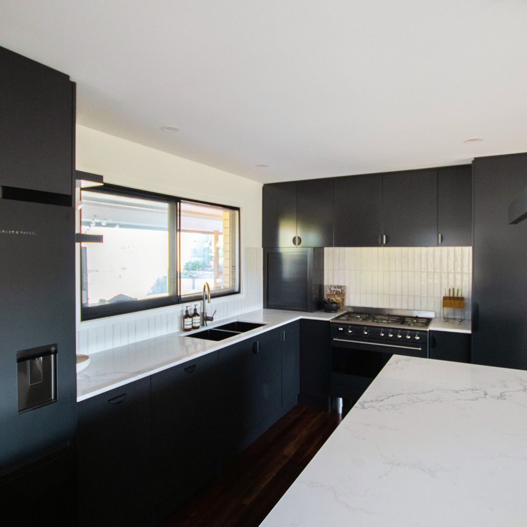 17. Monochrome Mosaic Backsplash with Vintage Radio Charm