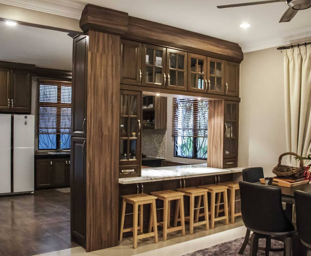 21. Intricate Lattice Panels with Terra Cotta Accents Dividing a Bright Kitchen Space