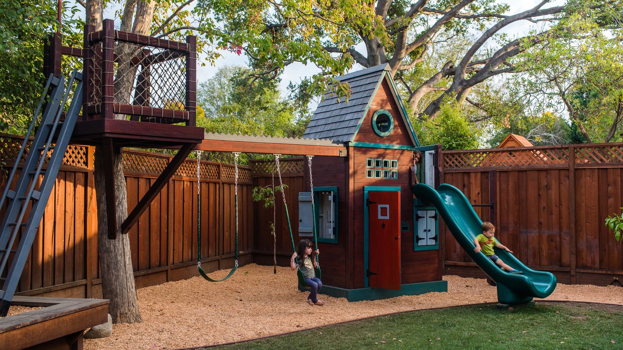 4. Vibrant Blue Slide Amidst Lush Greenery and Wooden Play Structures