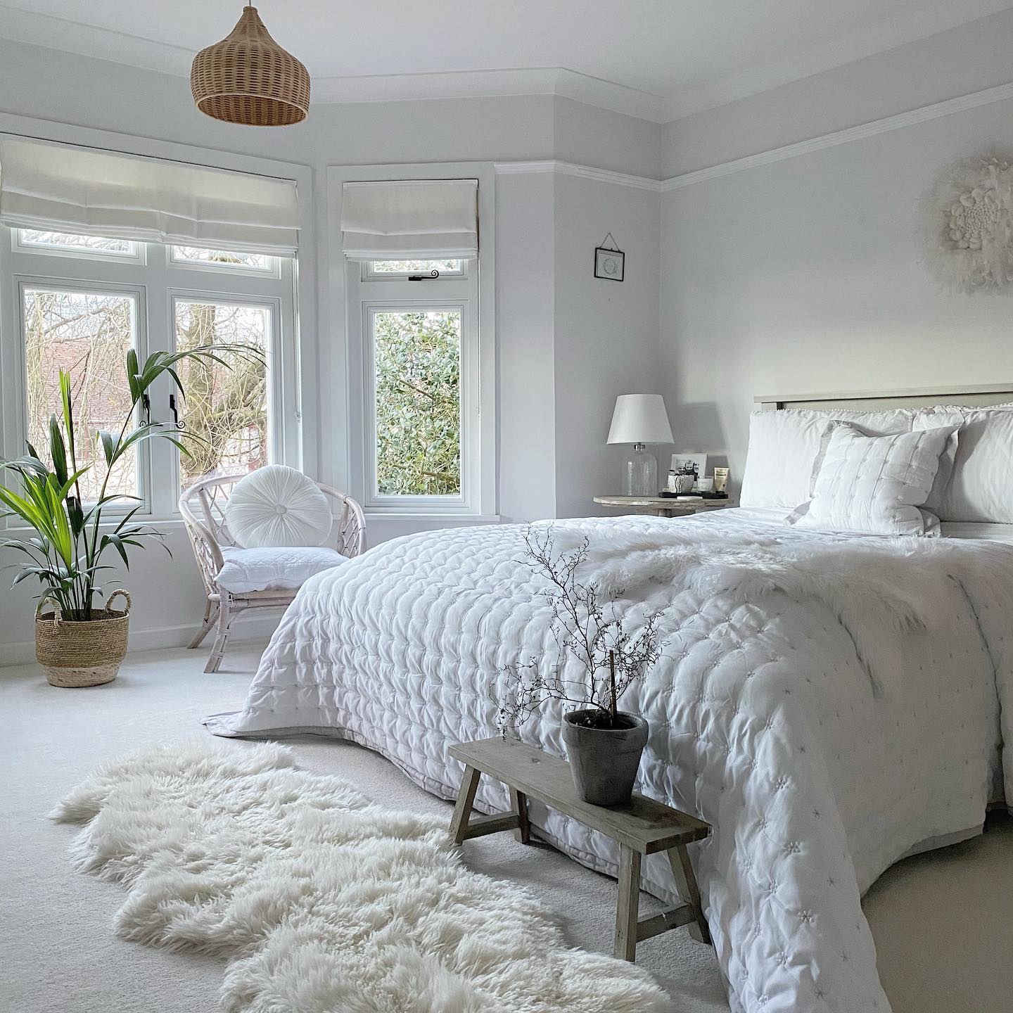 34. Bay Window Bookshelf with Potted Plant and Lantern Accents