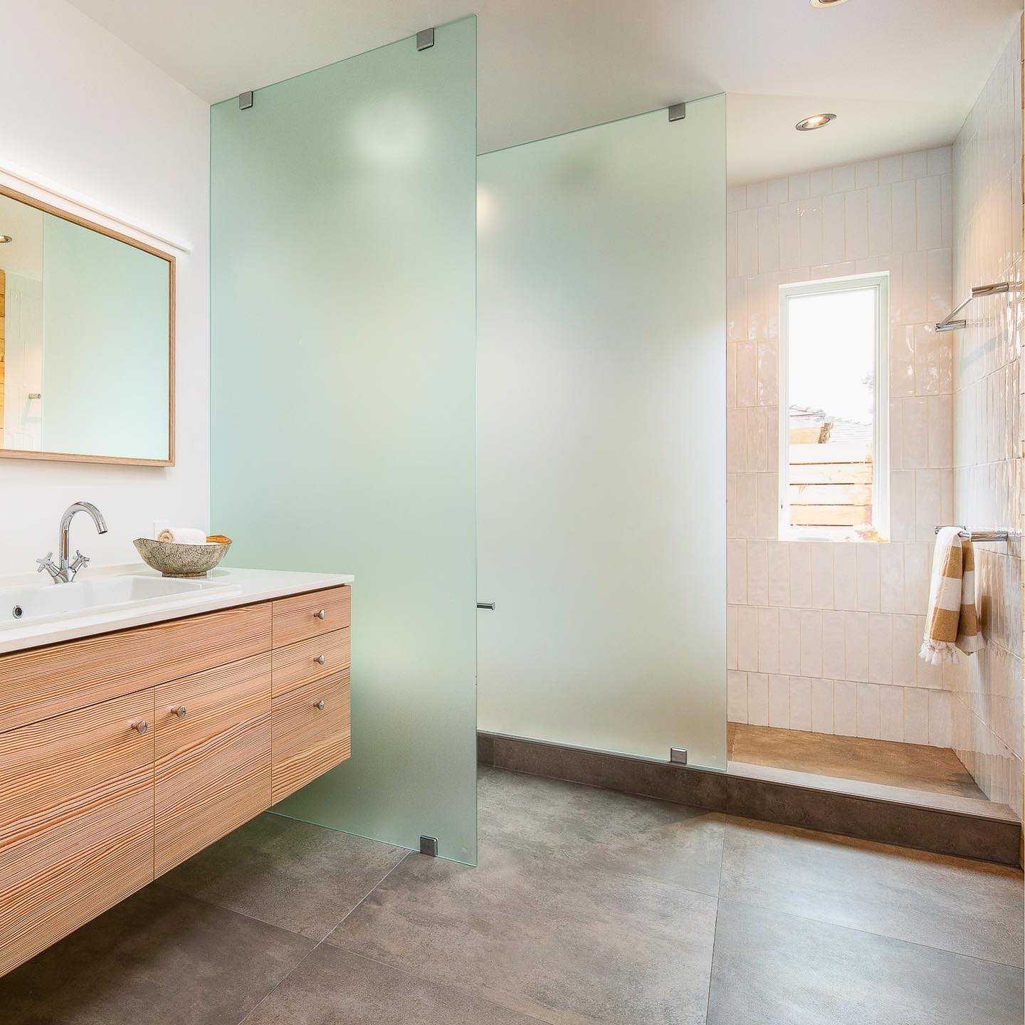 27. Midnight Cascade: a Shower Niche with Black Pebble Flooring and Floating Shelf