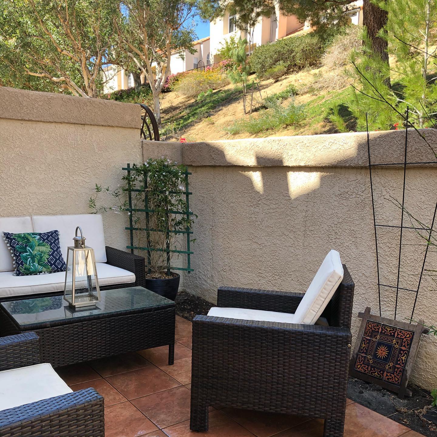 10. Vibrant Blue Adirondack Chairs with White Pergola and Rustic Barrel Planters