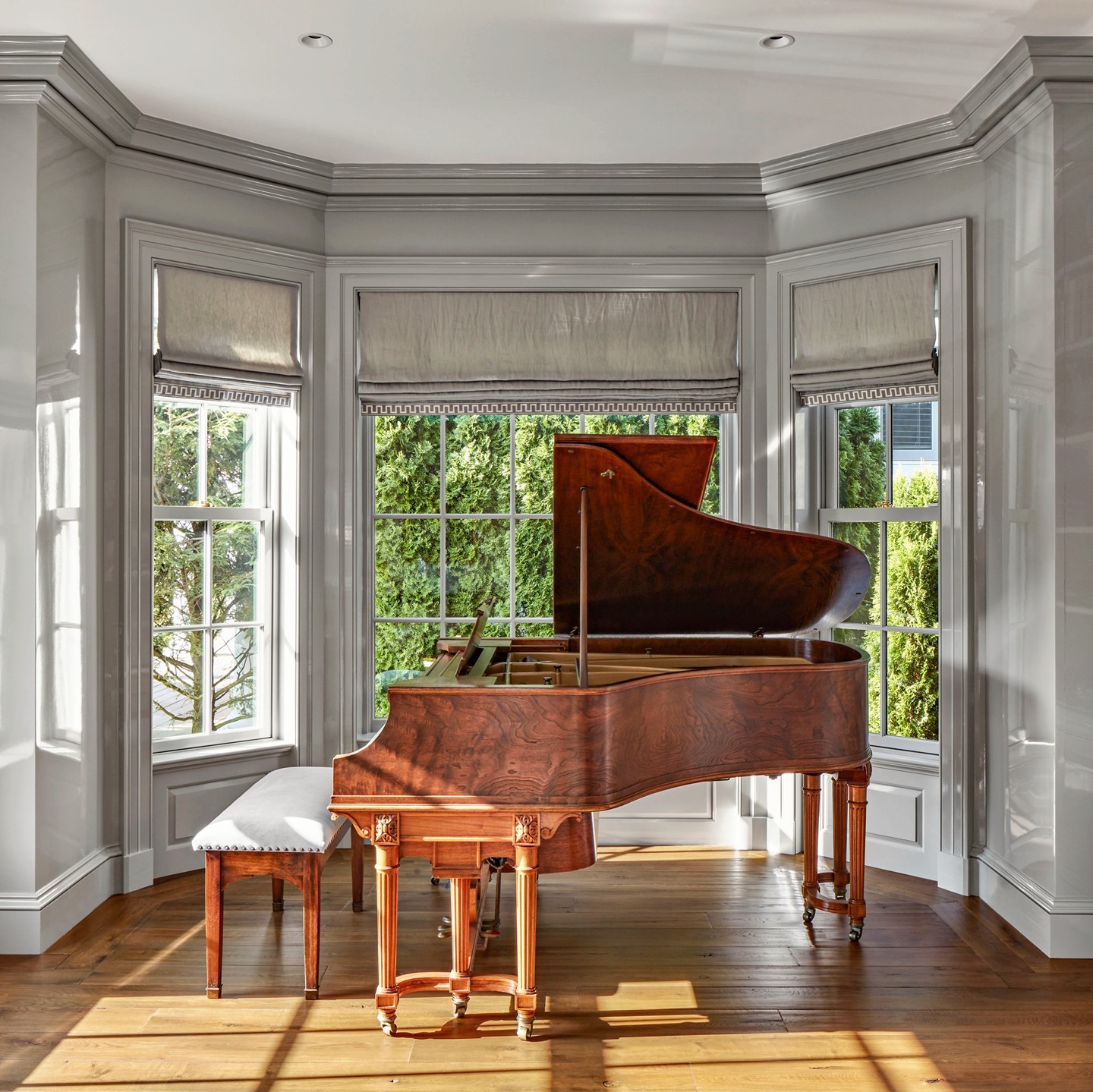 38. Bay Window with Crimson Cushions and Faux Fur Throws Creates a Cozy Nook