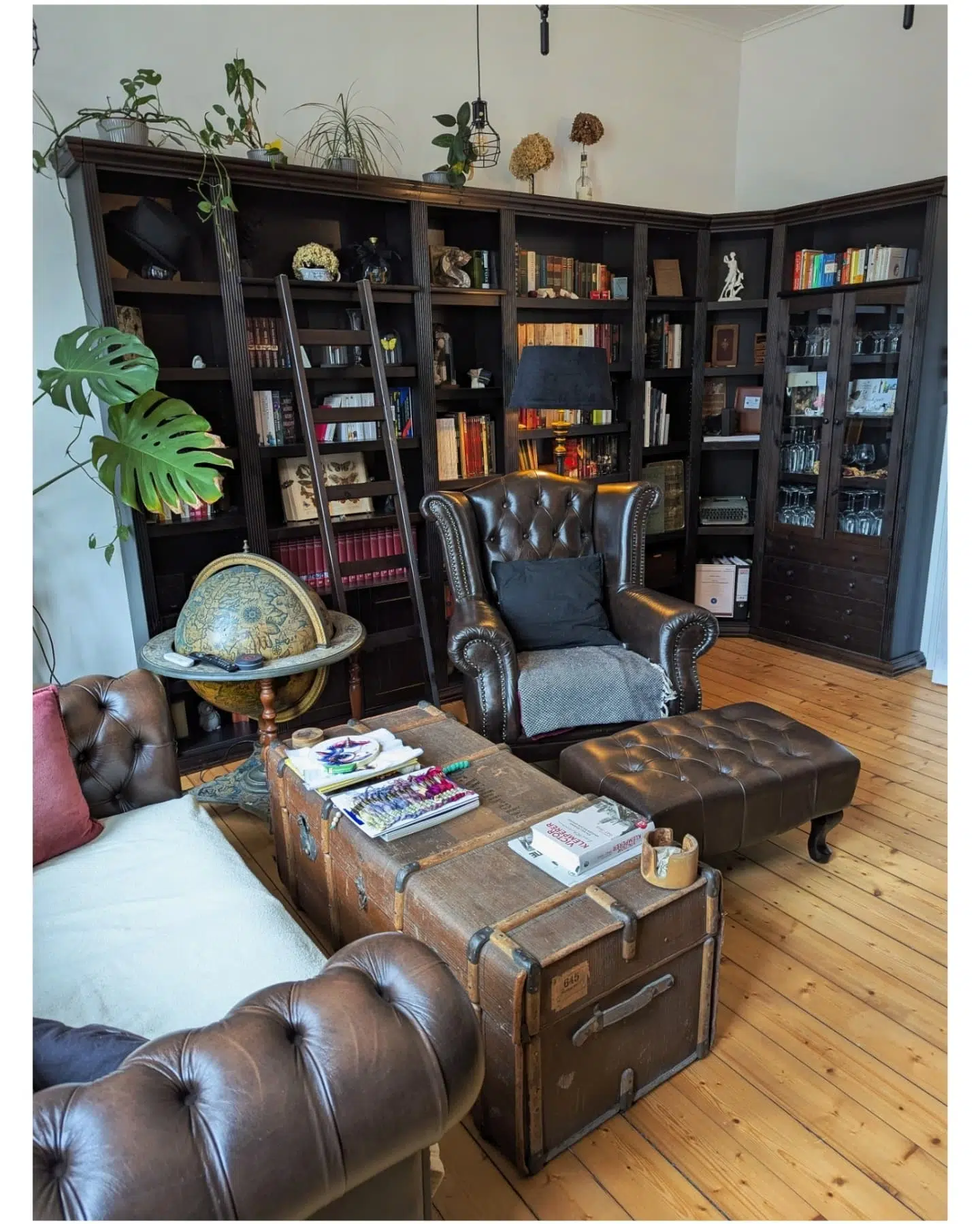 19. Bookshelf with a Ladder Of Literary Escape, Flanked by Geometric Vases