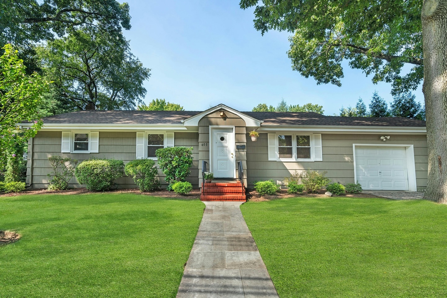 6. Ranch Home with Turquoise Trim and Stone Accents Embraces Mid-century Charm