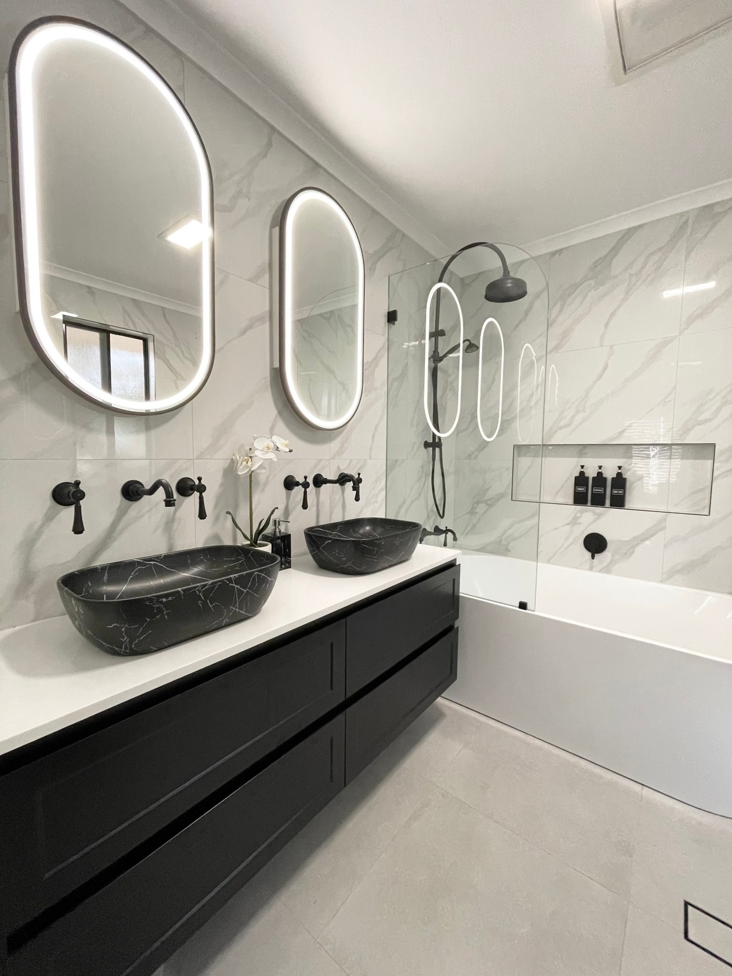 28. Vintage Rotary Phone Accent In Monochrome Bathroom with Geometric Tiles