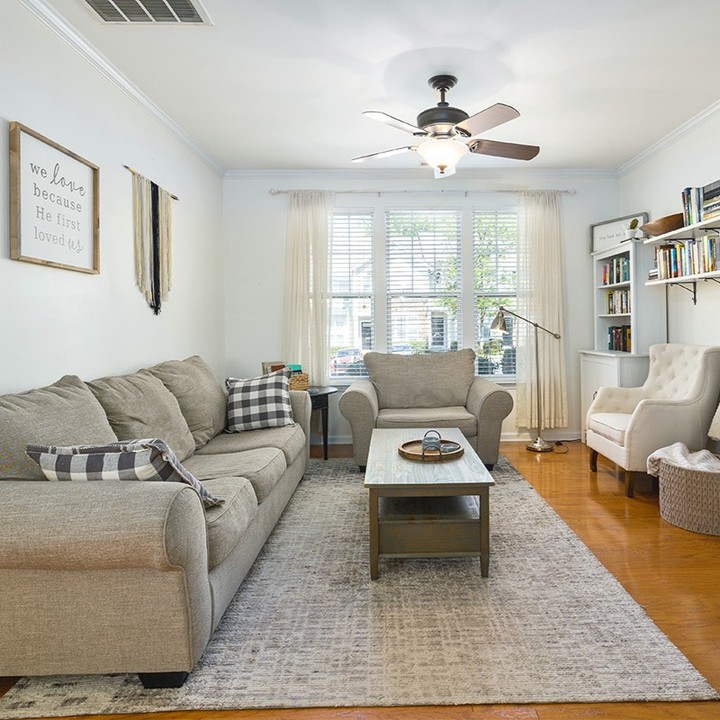 22. the Crimson Couch and Geometric Rug Fusion In a Sunlit Living Space