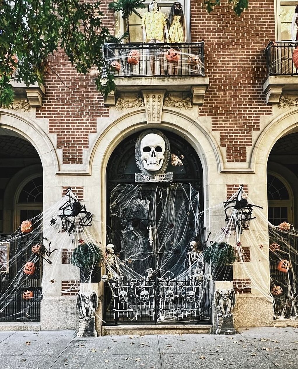 12. Spooky Skeleton Hand Holding a Lantern Amidst Cobwebs and Bats