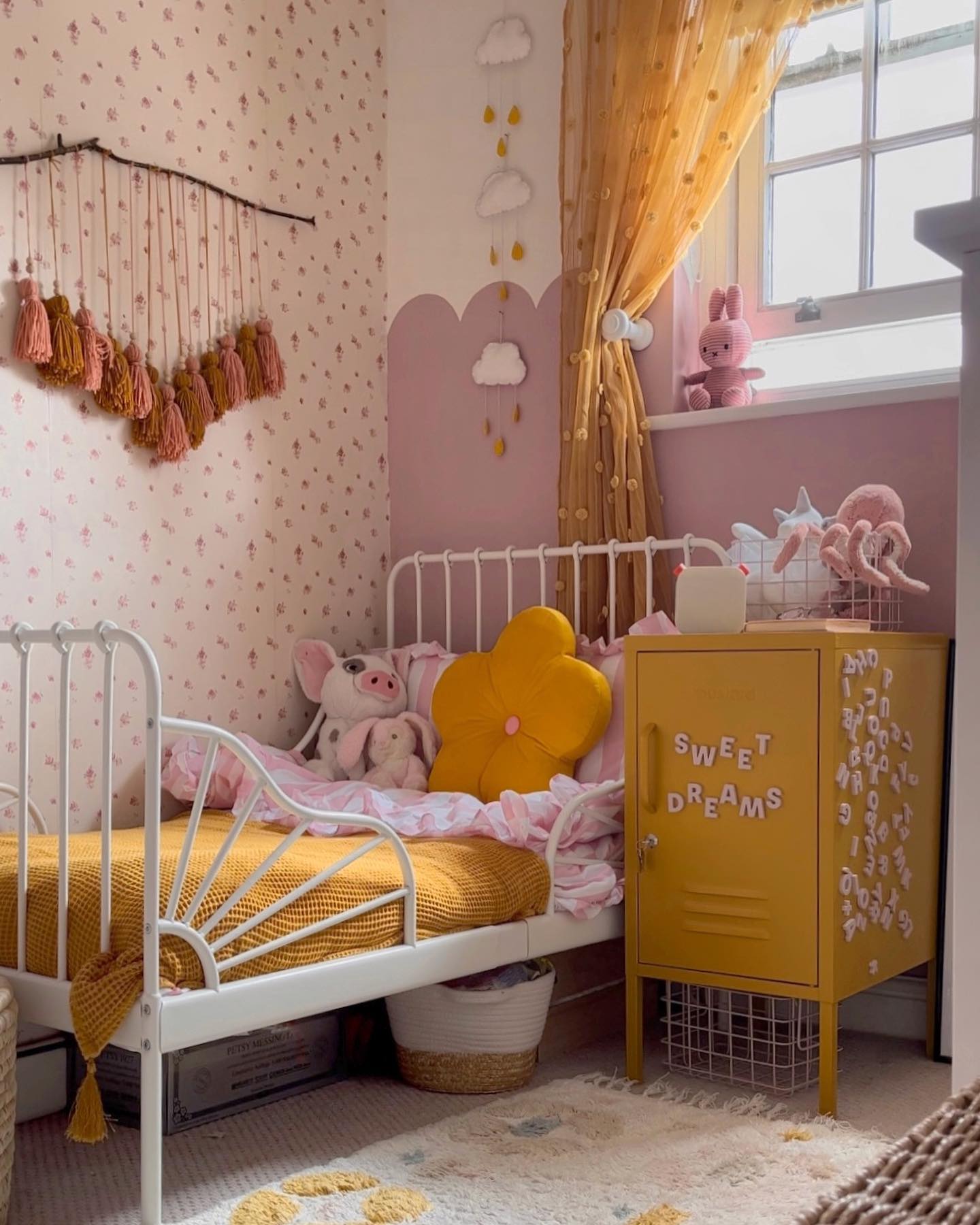 7. Delicate Blush Canopy Over Vintage Crib with Whimsical Floral Wall