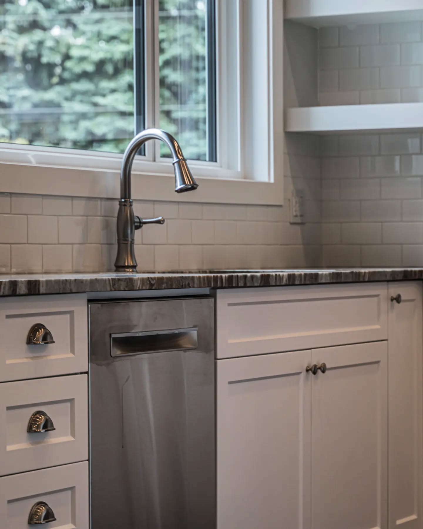25. a Ceramic Swan Neck Faucet Over a Hammered Copper Sink with Butcher Block Surround