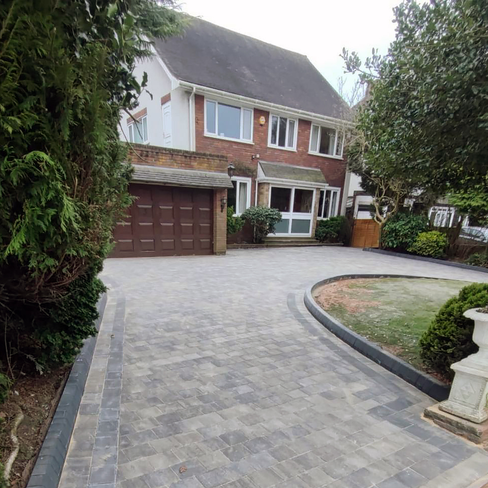 8. Cobblestone Pathways and Lush Hydrangea Borders Frame the Modern Driveway