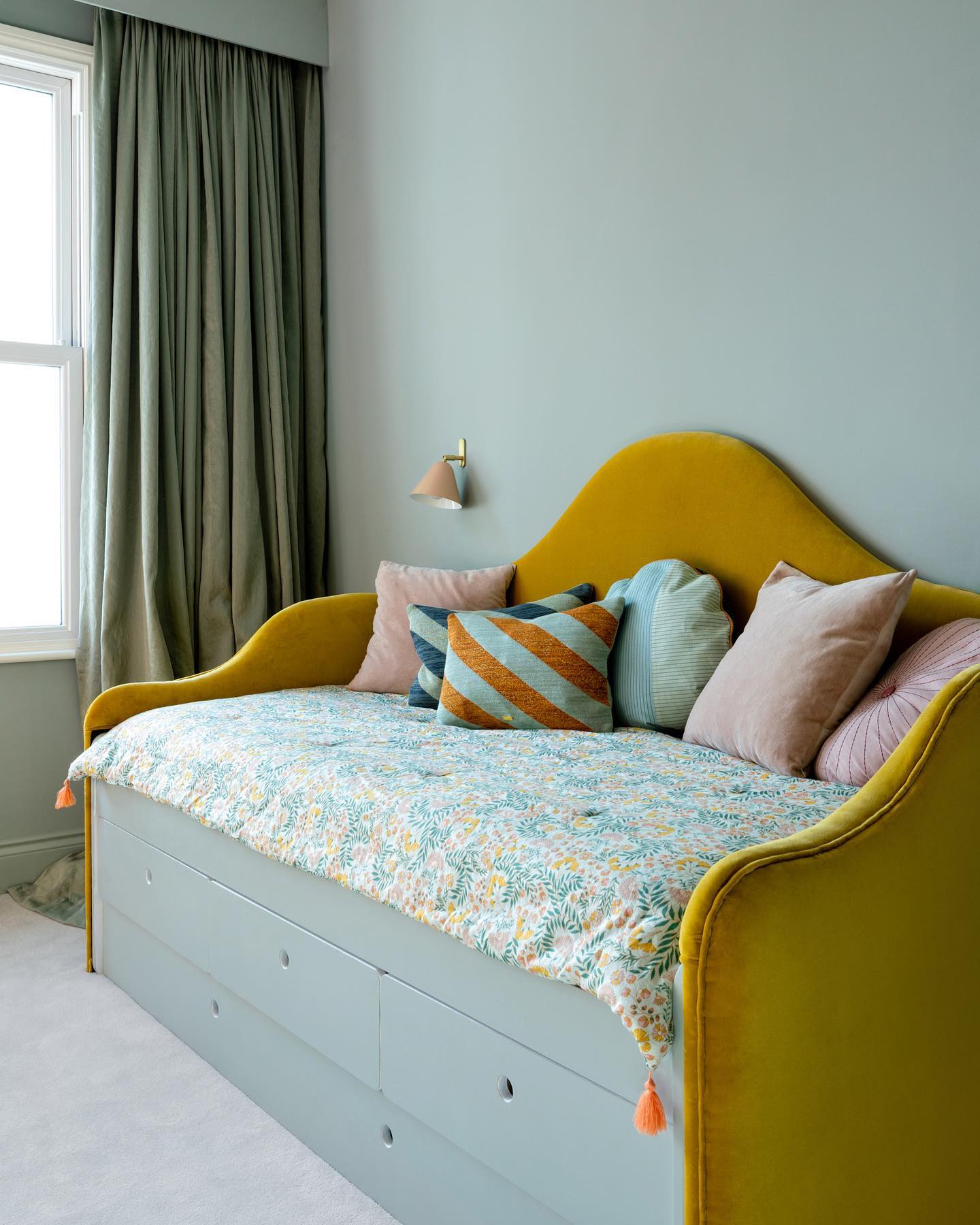 16. the Verdant Canopy: a Daybed Nestled Under a Lush Green Garland