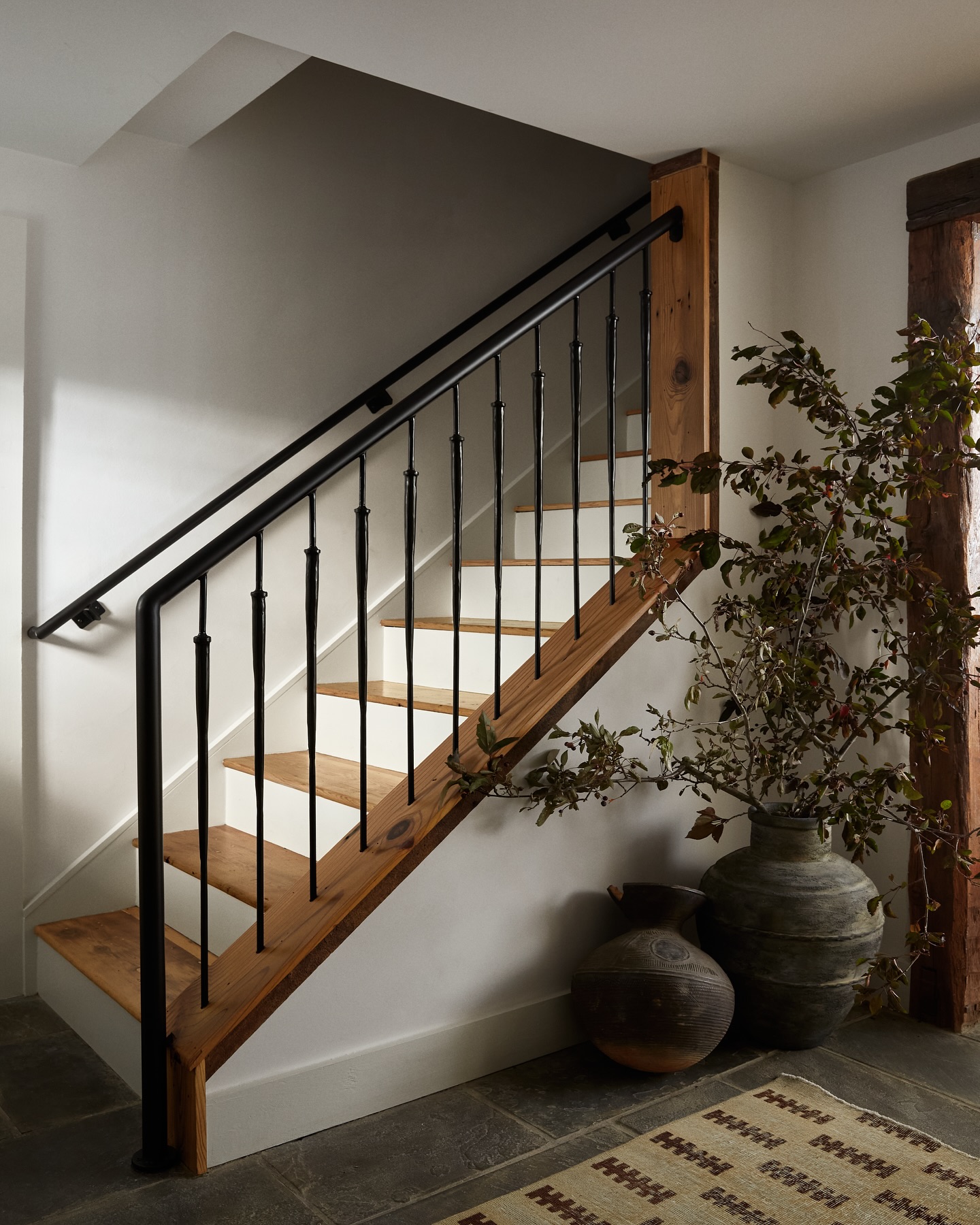 25. Vibrant Crimson Chandelier Casting Shadows on Geometric Wall Panels