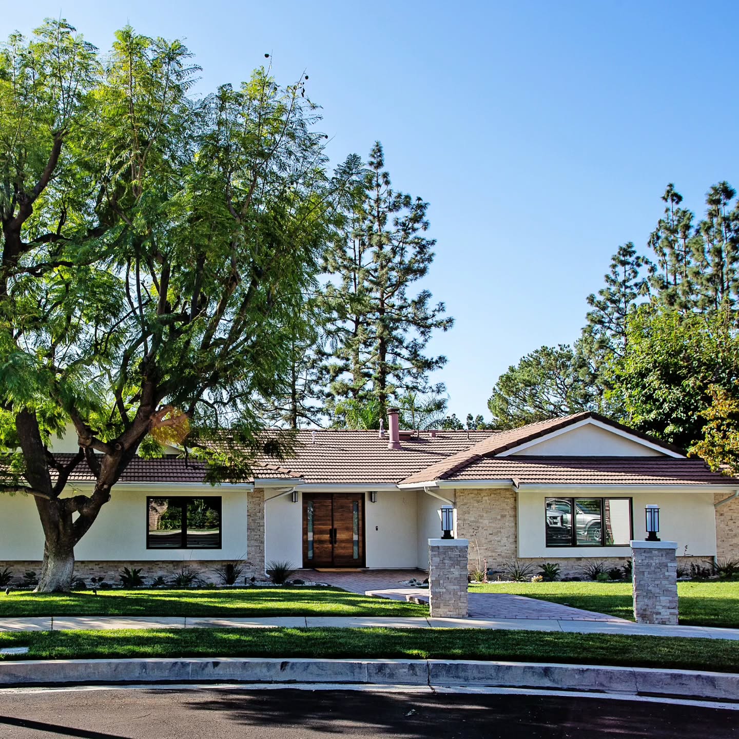 13. Rustic Stone Accents Meet Vibrant Red Door In a Prairie Landscape