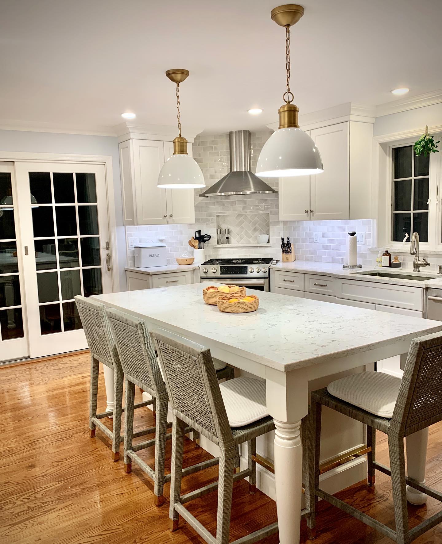 10. White Quartz Waterfall Edge with Geometric Mosaic Accents