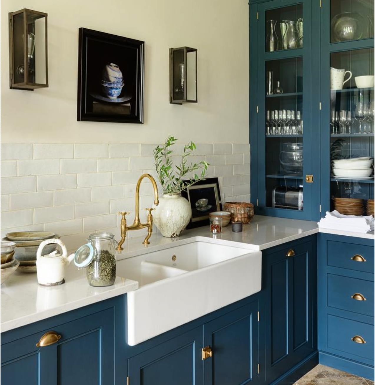 14. Twilight Blue Cabinets with Geometric Copper Accents In a Compact Kitchen