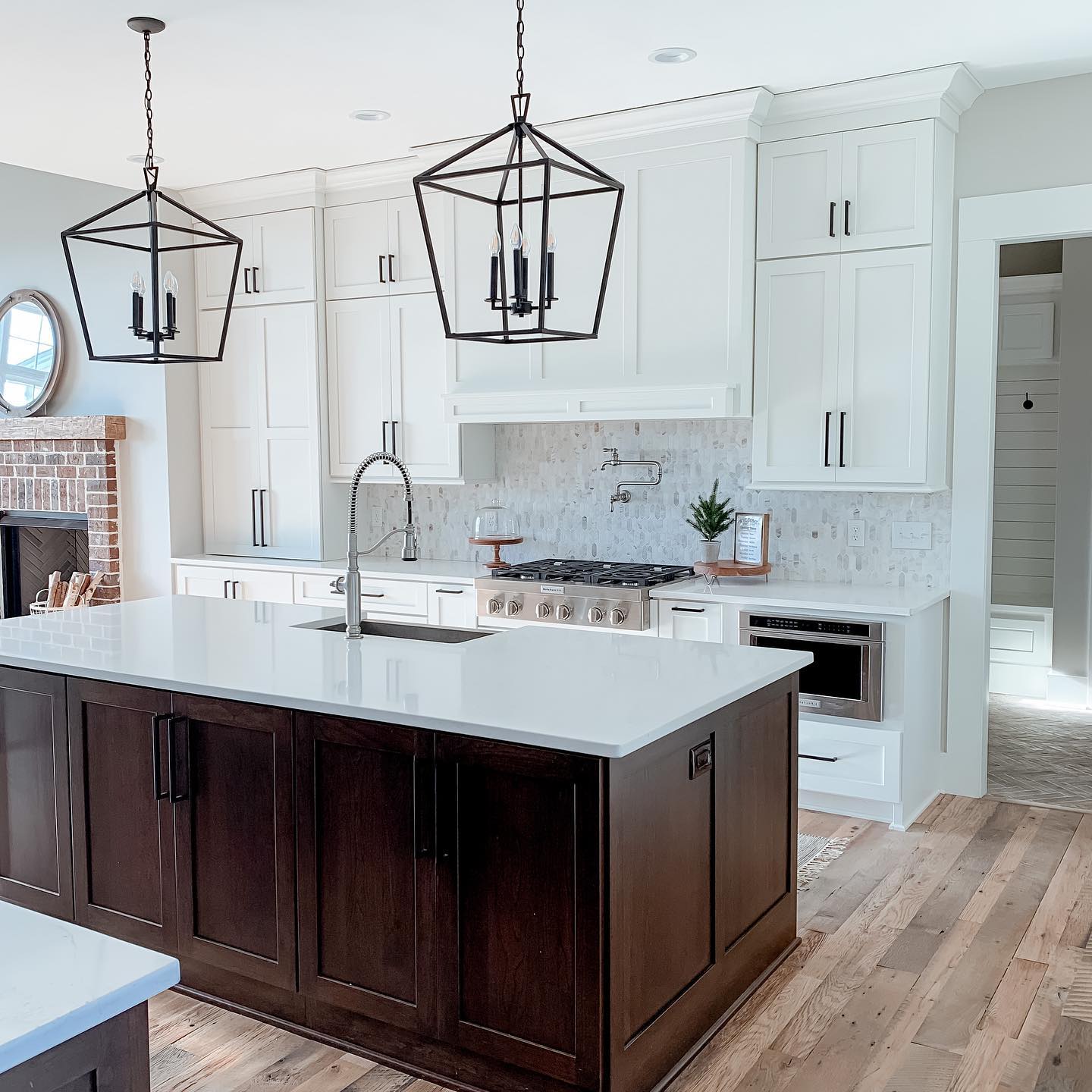 3. White Quartz Herringbone Backsplash with Midnight Black Grout and Gold Accents