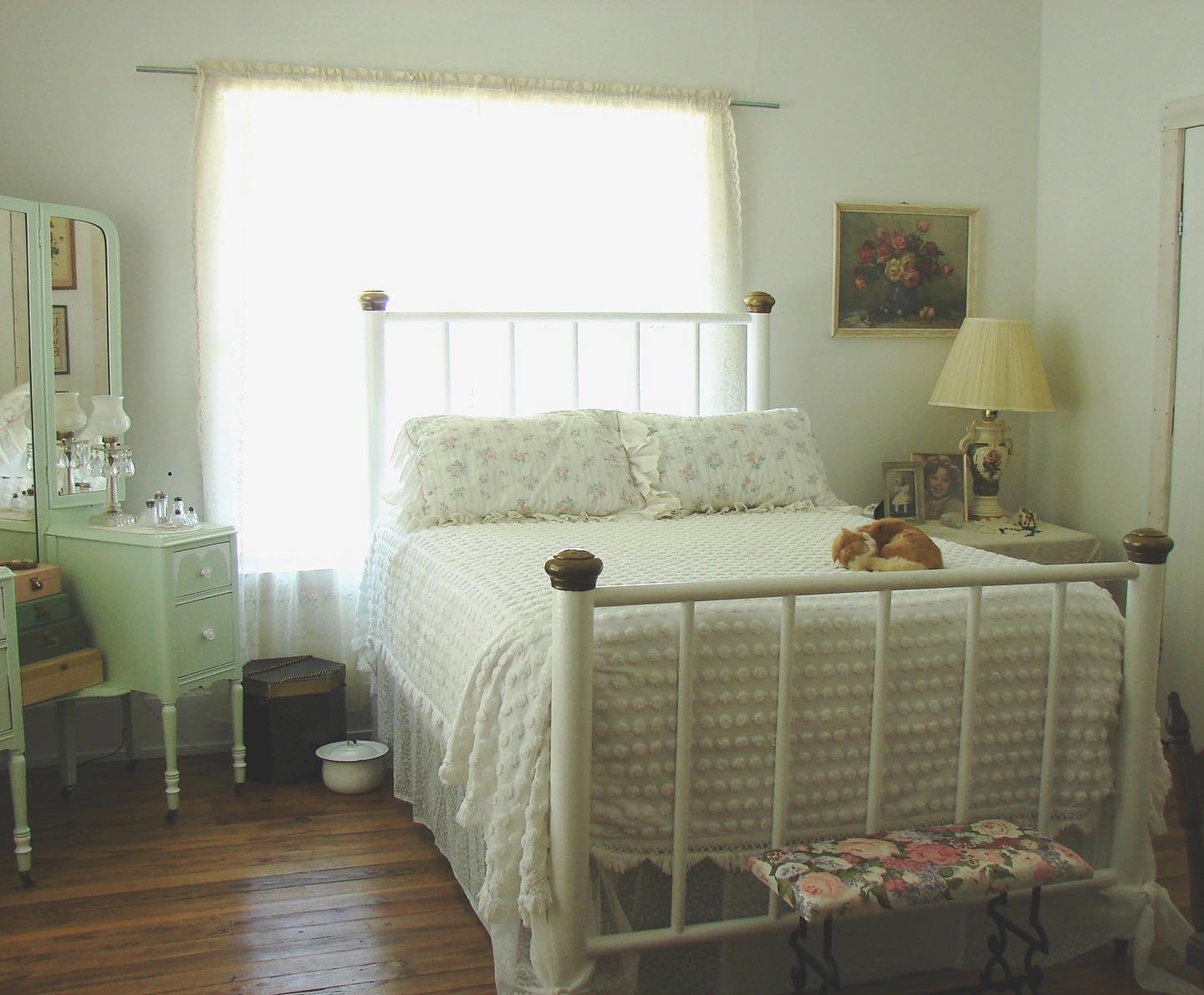 17. Soft Moss Green Canopy Bed with Delicate Lace Curtains and Wildflower Accents