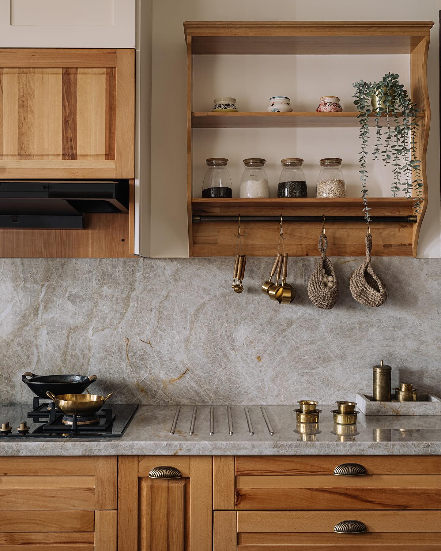 3. Floating Bookshelf with Potted Greenery and Vintage Vases Above Cabinets