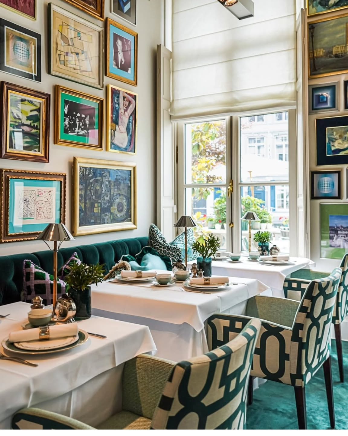 22. Velvet Ribbon Cascade: a Living Room Wall Where Photos Dance with Textiles