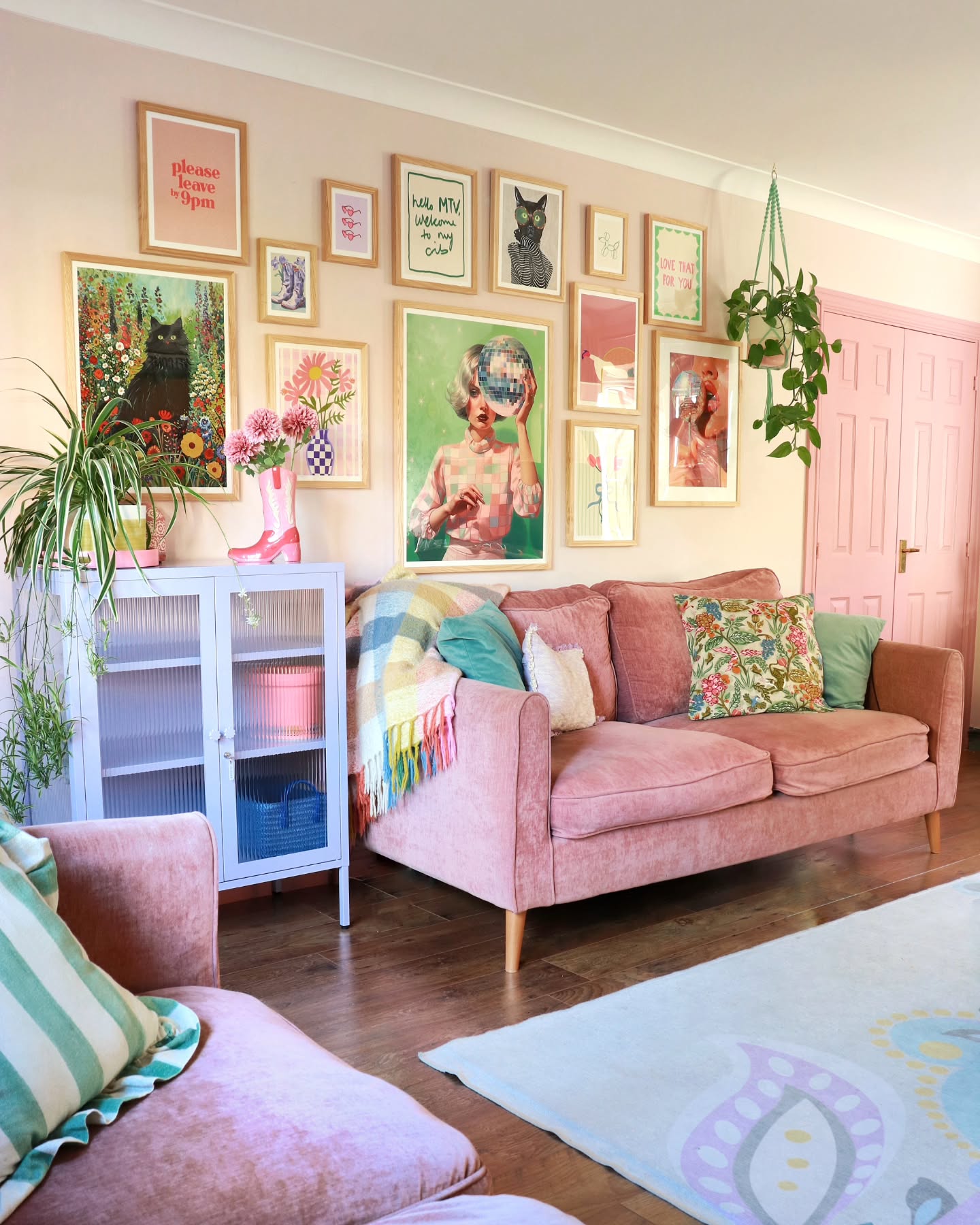 10. Cascading Frames and Vintage Map Mural In Eclectic Living Room Display