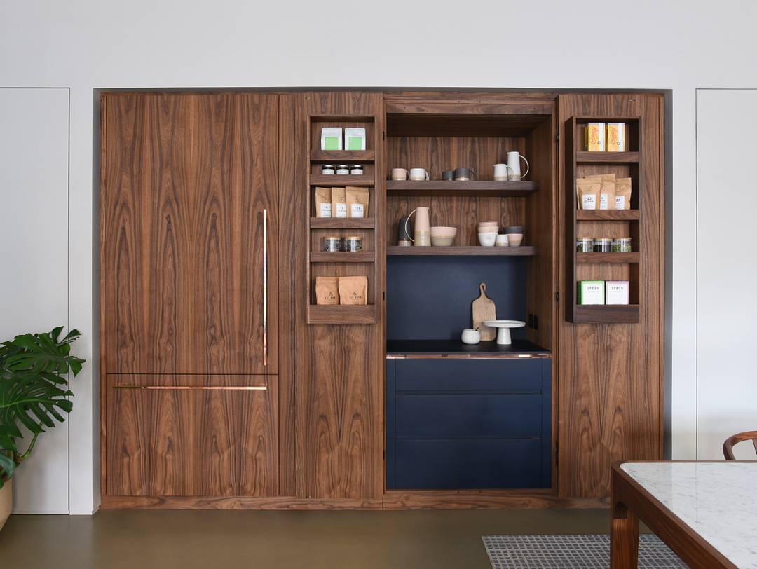 22. a Copper-clad Door with Geometric Glass Inserts Conceals a Rustic Pantry