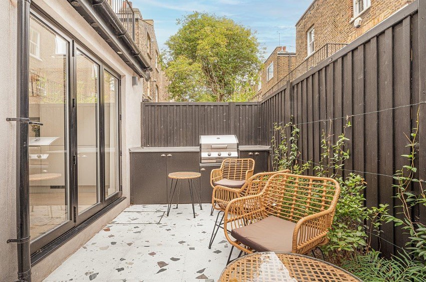 9. a Sunlit Haven with a Diy Pallet Wood Bench and Terracotta Pot Planters
