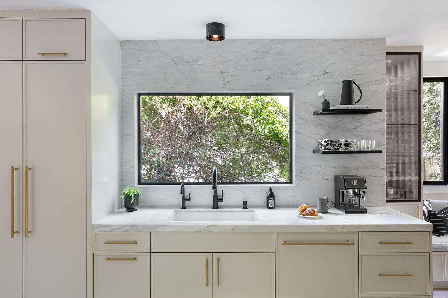22. Above the Kitchen Sink: Where Vintage Brass Meets Modern Minimalism