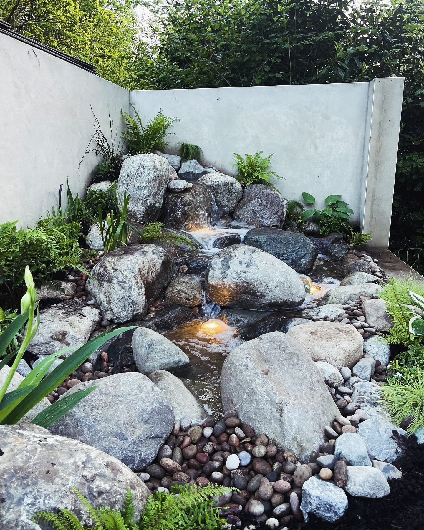 7. Moonlit Cascade: a Stone-lined Waterfall with Fern-laced Edges