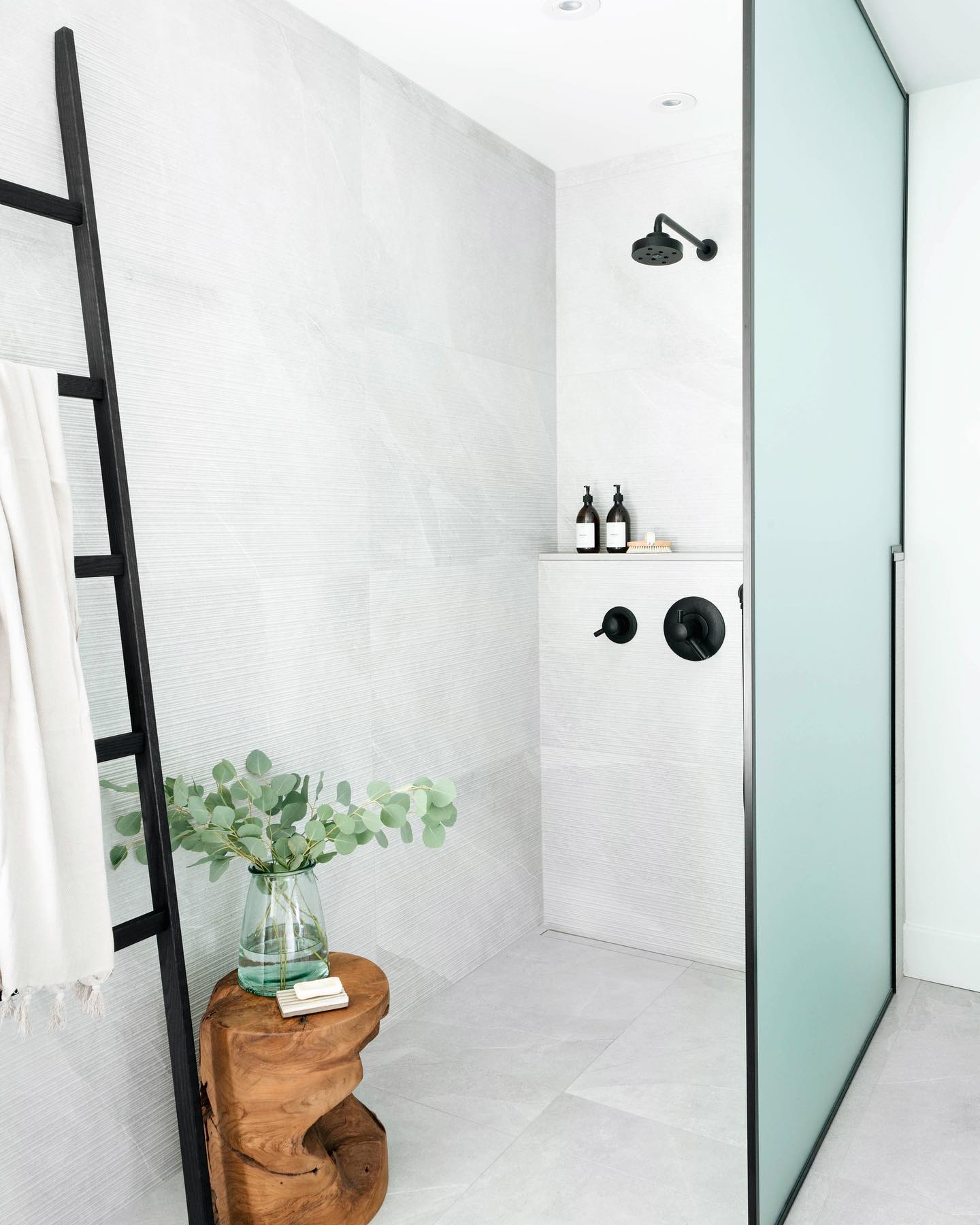 1. a Frosted Glass Partition with a Geometric Mosaic Tile Accent