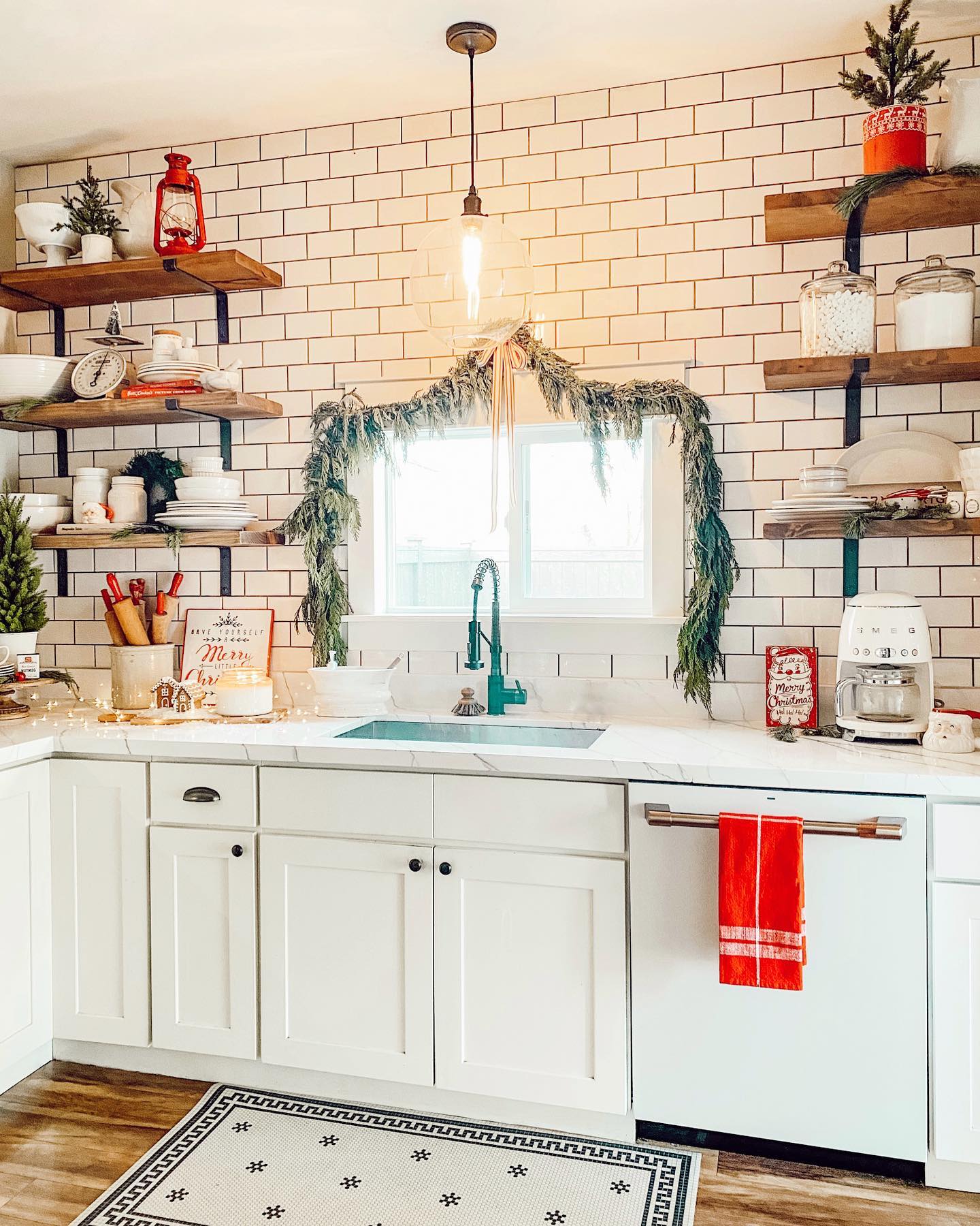 12. Festive Gingerbread Men Garland Woven Through Crimson Ribbon Above White Cabinets