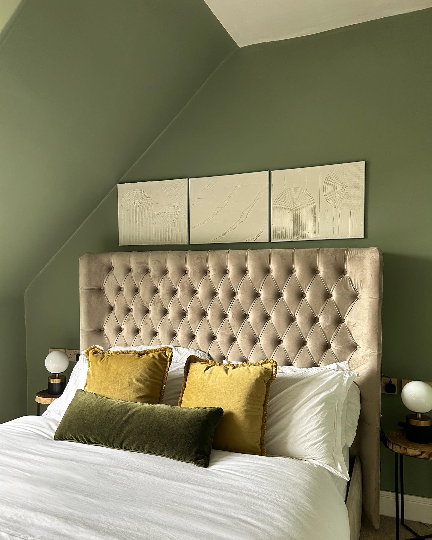 16. Sage Green Velvet Headboard with Macrame Wall Hangings and Faux Fur Throws