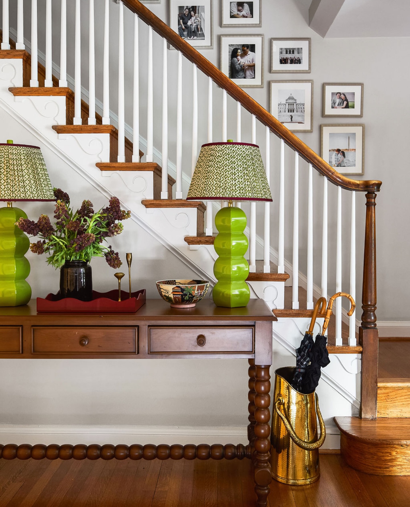 2. Velvet-covered Console with Gilded Mirror Reflection In Foyer