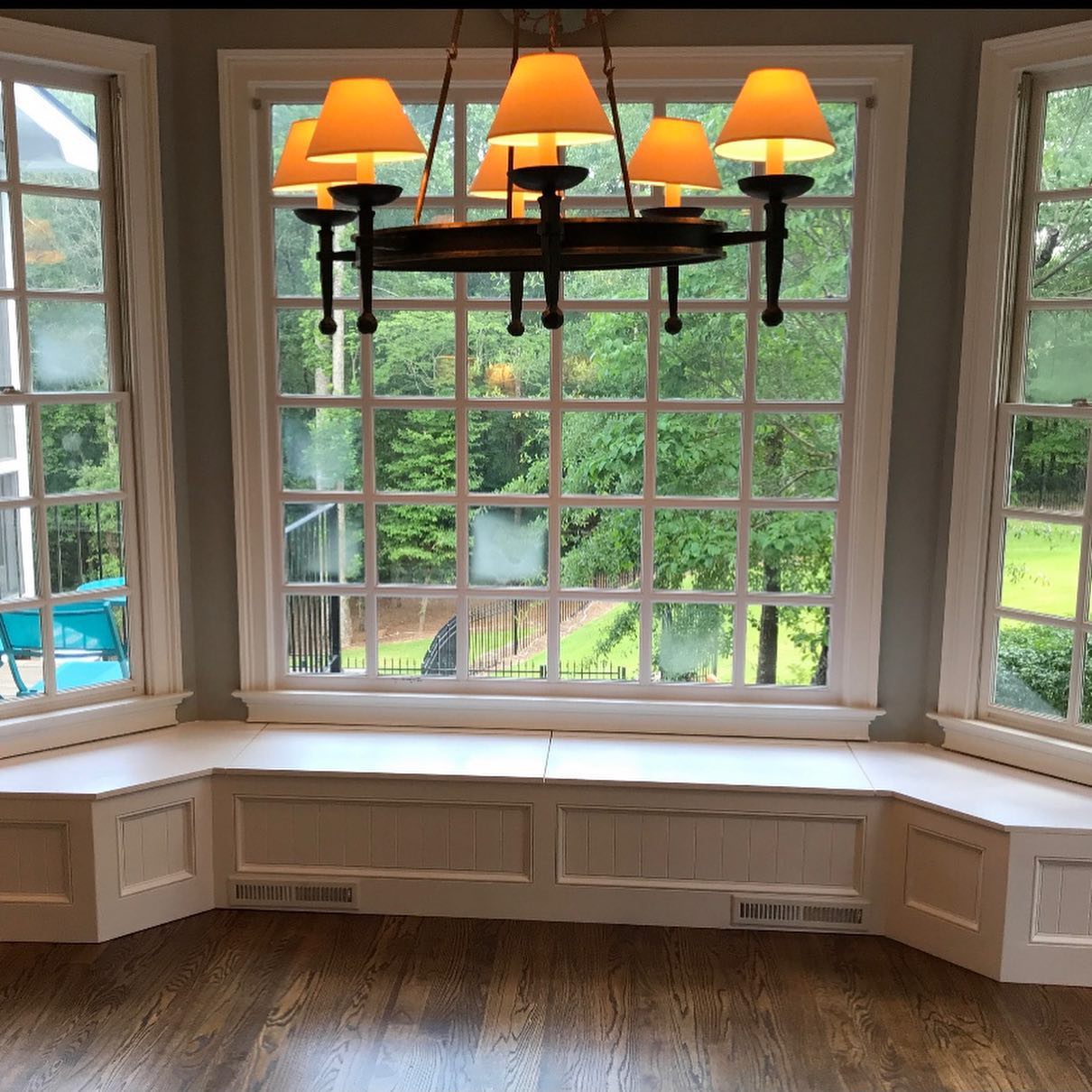 33. a Sunlit Symphony Of Greenery and Rattan Amidst White Frames