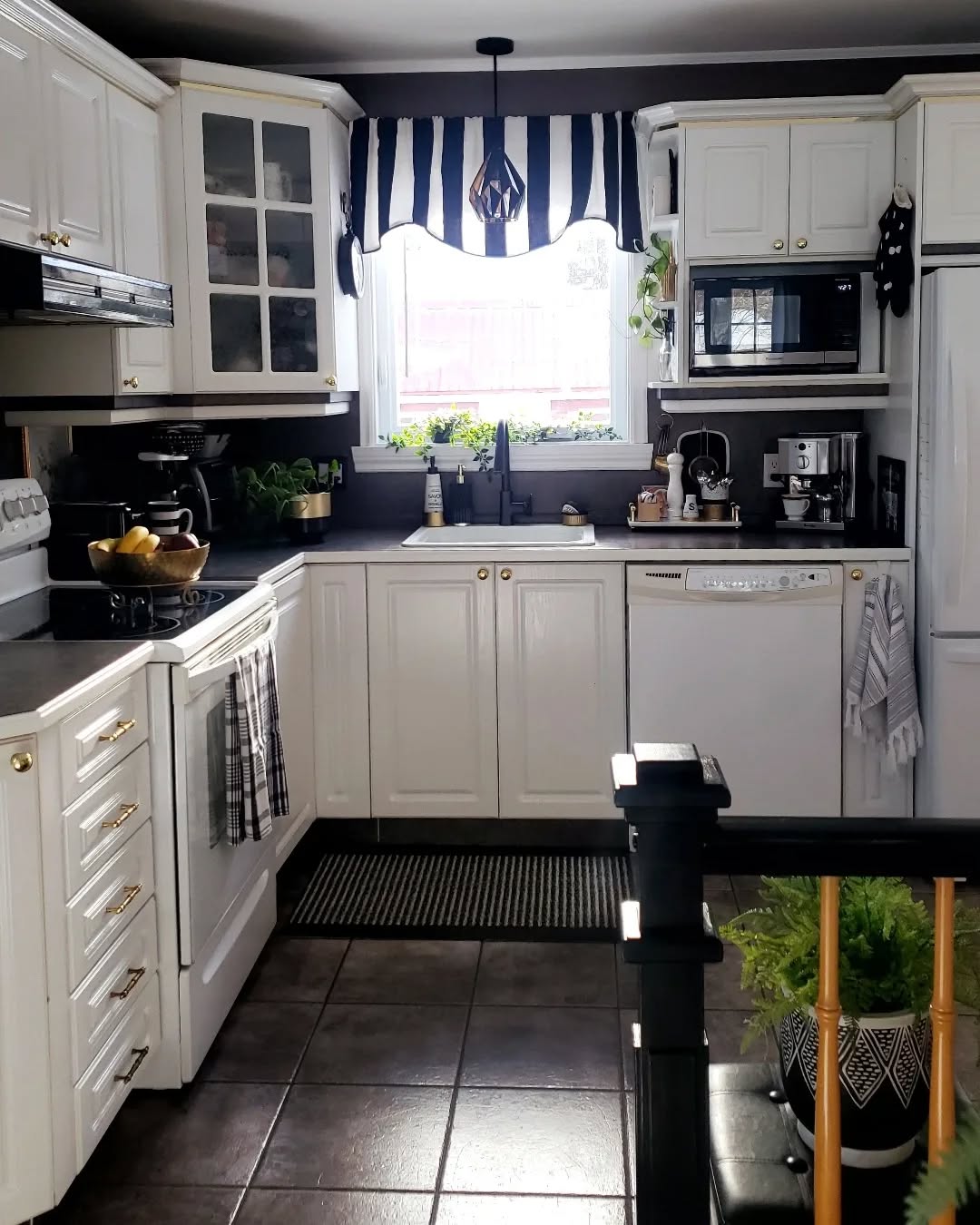 30. Sleek Monochrome Kitchen with Geometric Pendant Light and Checkerboard Floor