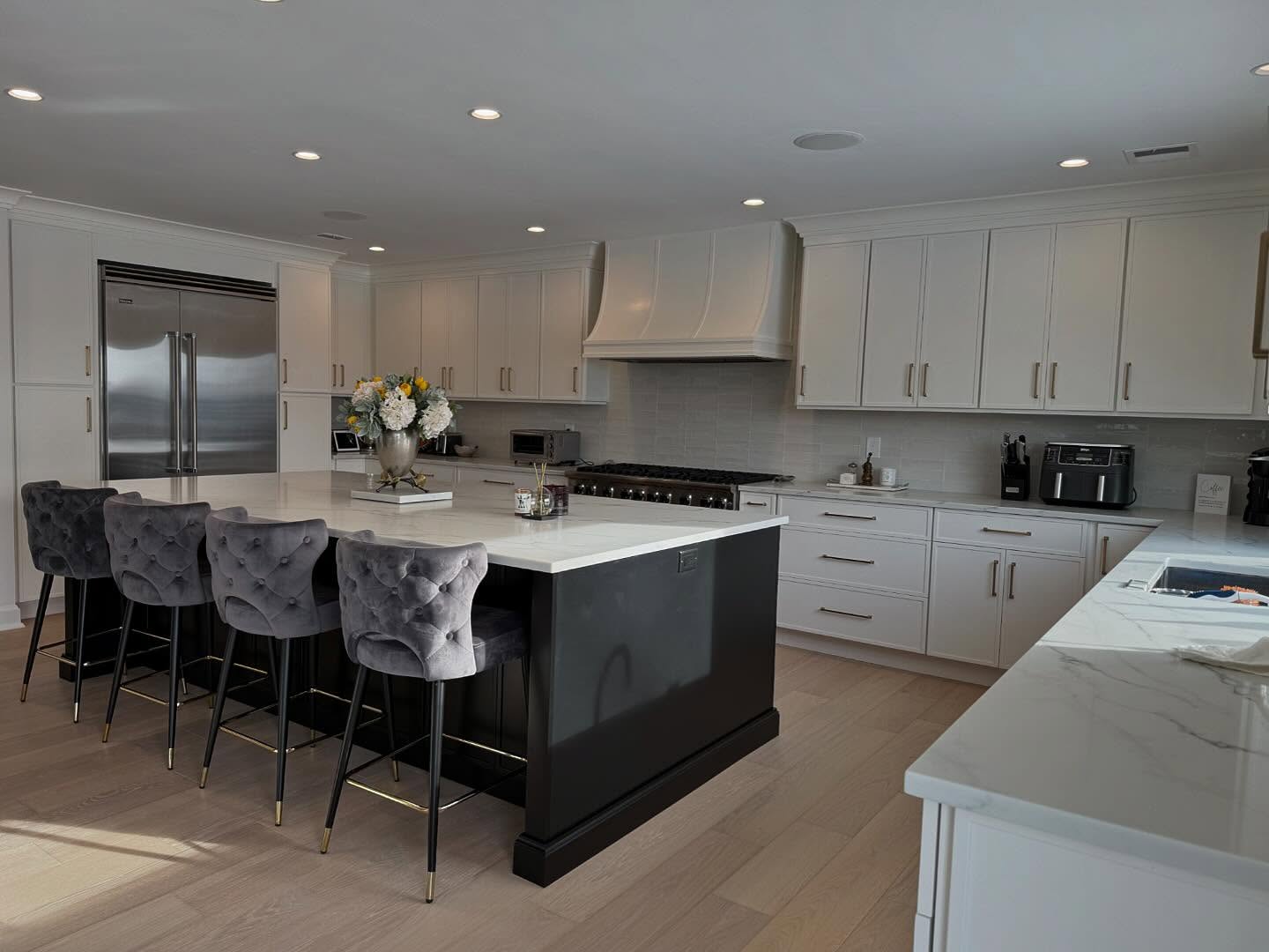 25. Glossy Black Cabinets Meet Polka Dot Backsplash In Monochrome Marvel