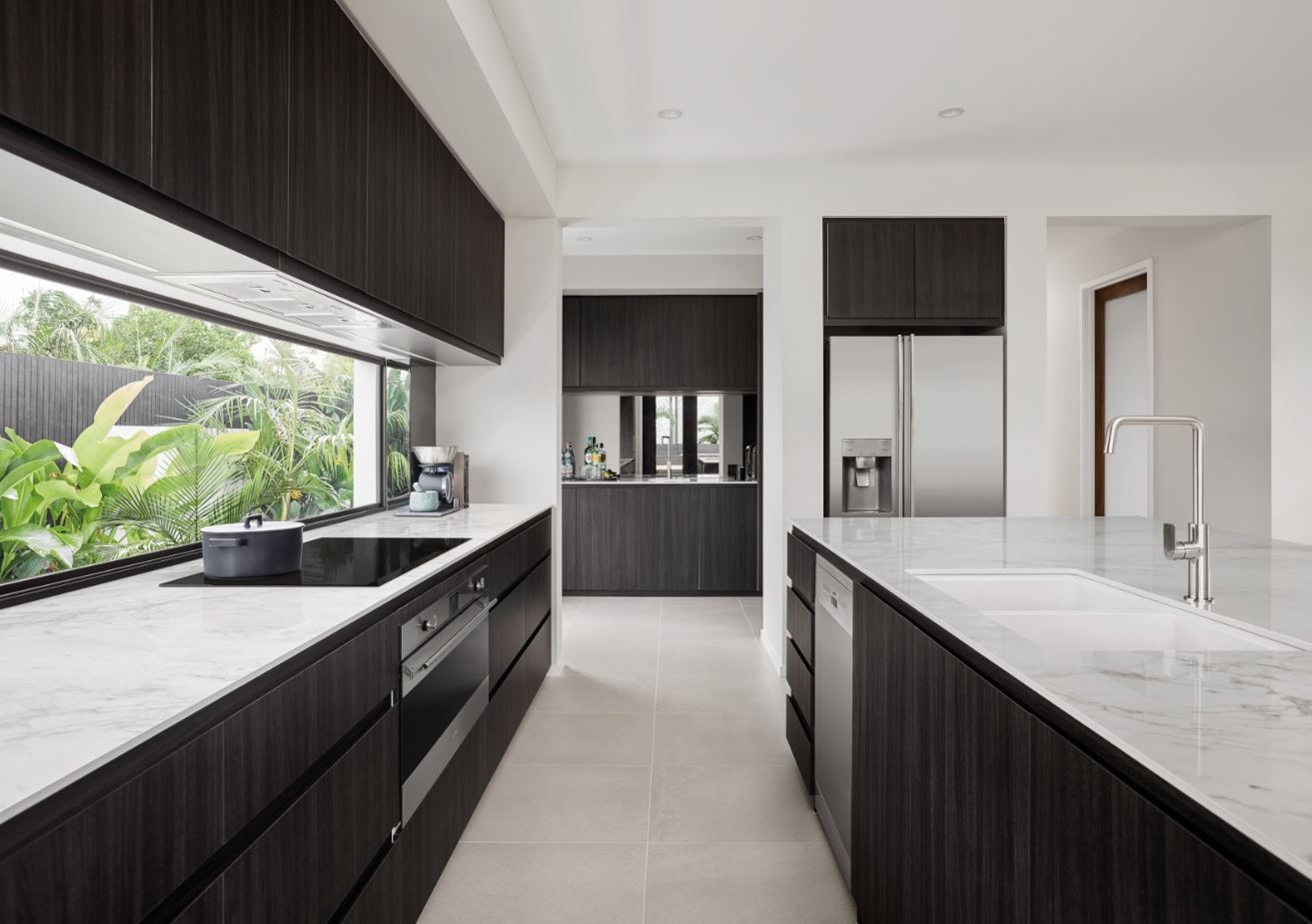 8. Sleek Monochrome Kitchen with Geometric Tile Accents and Industrial Pendant Lights