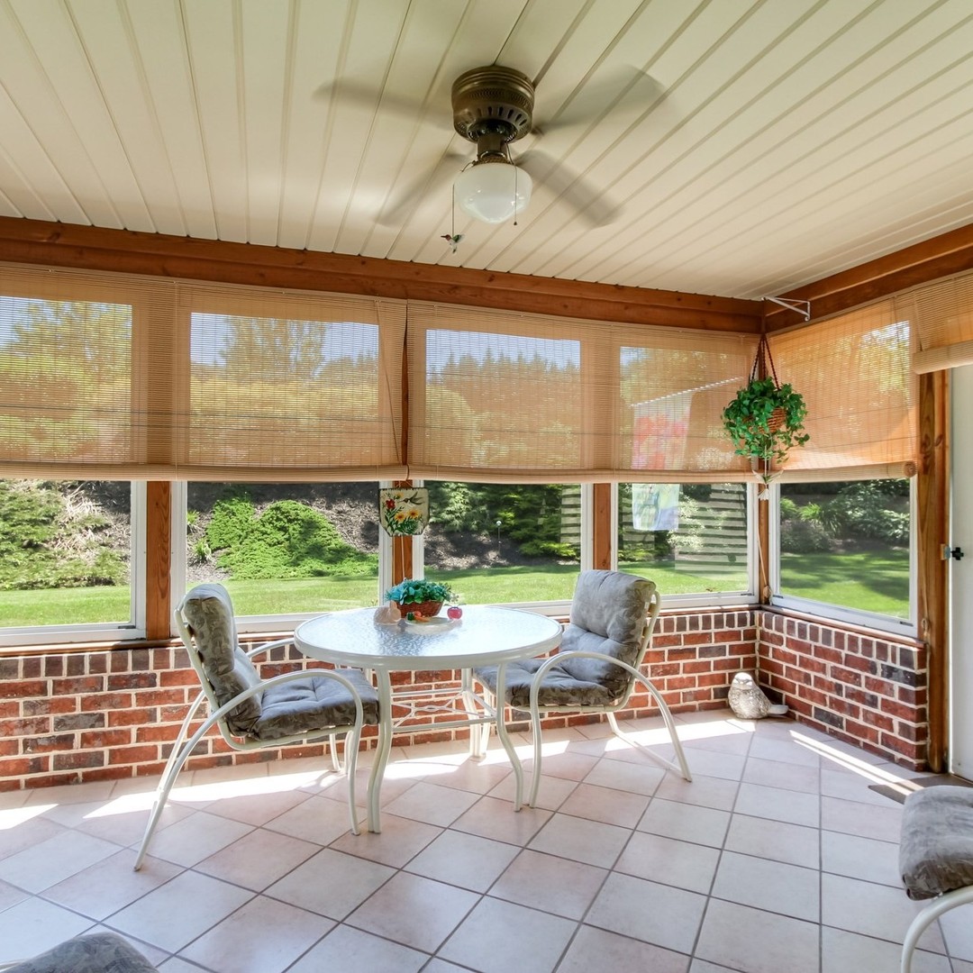 22. Tropical Oasis with a Bamboo Accent Wall: the Enclosed Sunroom Escape