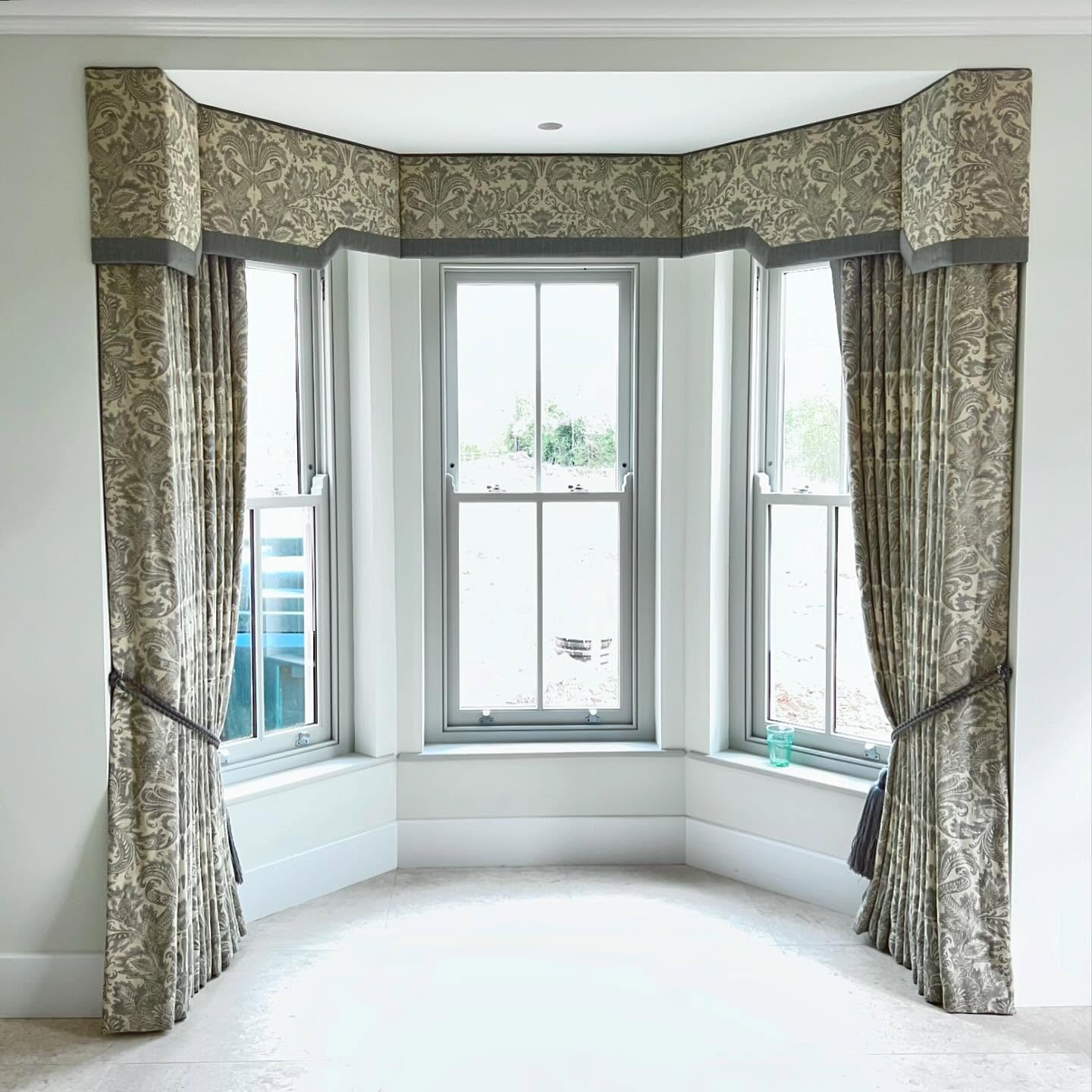 25. Sunlit Serenity: a Vintage Typewriter and Lush Ferns on a Distressed White Bay Window Sill