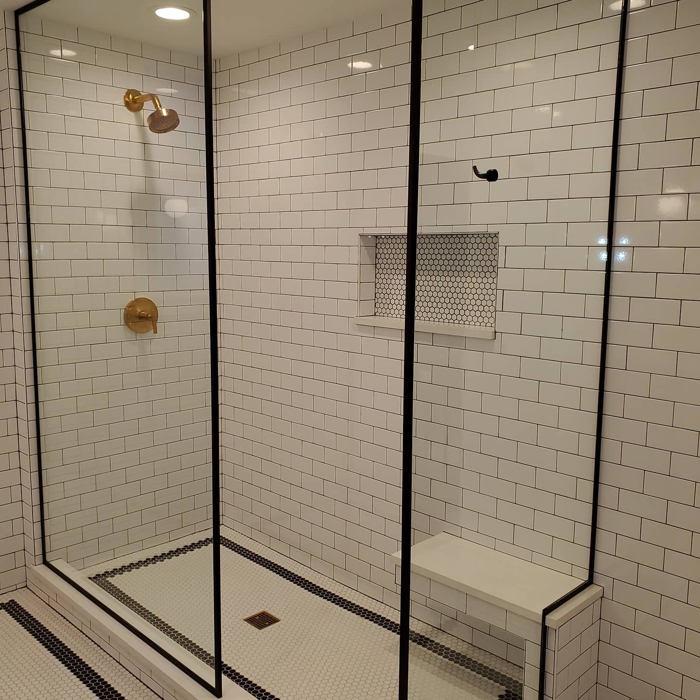 6. the Frosted Glass Partition with Pebbled Floor Tiles and Geometric Wall Accents