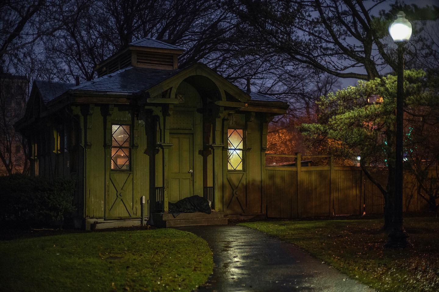 18. Cobblestone Pathway and Wooden Bench Amidst Sunlit Yellow Wildflowers