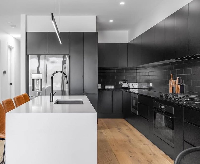 34. Black and White Mosaic Backsplash with Industrial Piping Accents