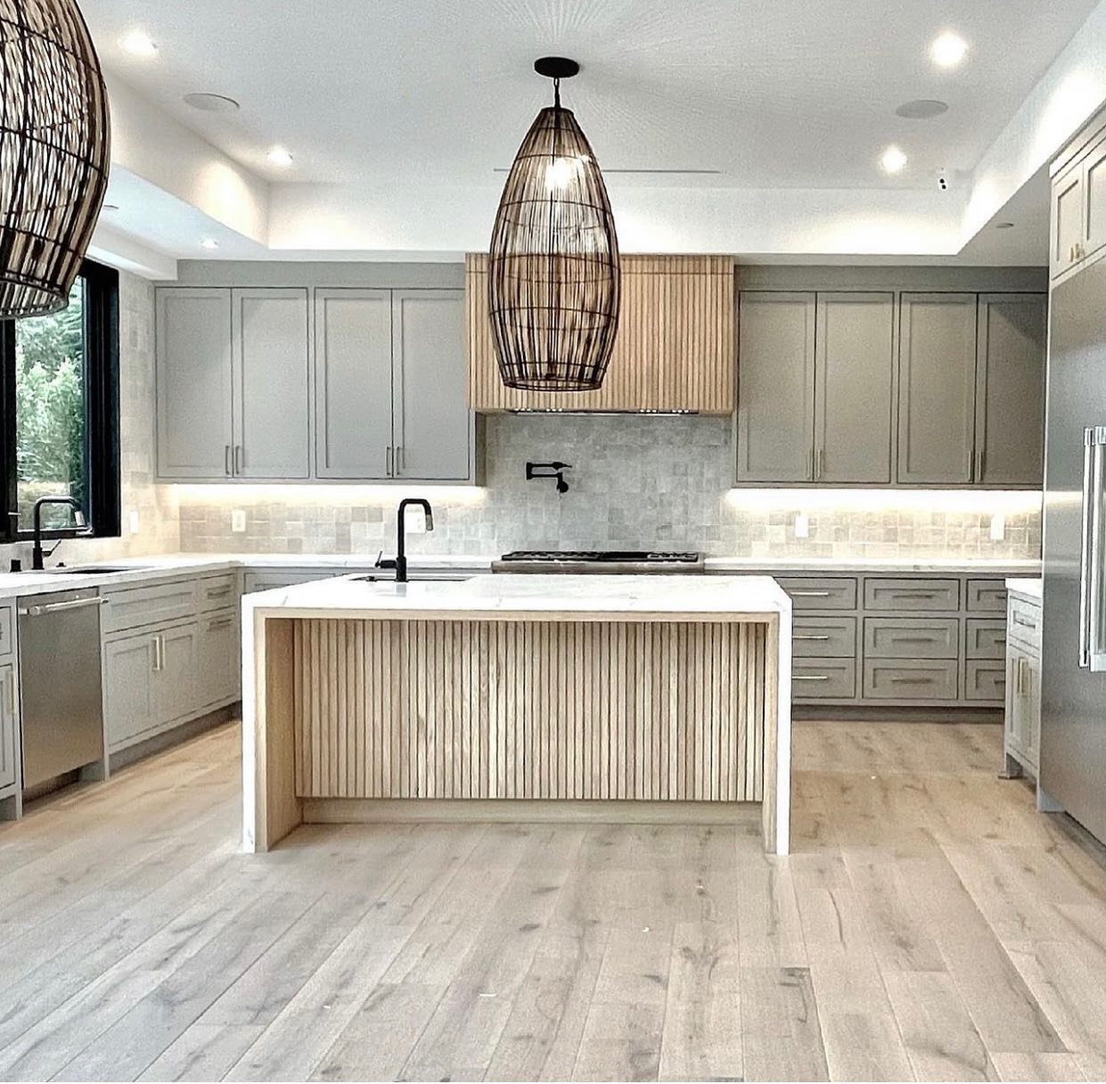 11. White Subway Tiles with Intricate Mosaic Borders In a Modern Farmhouse Kitchen