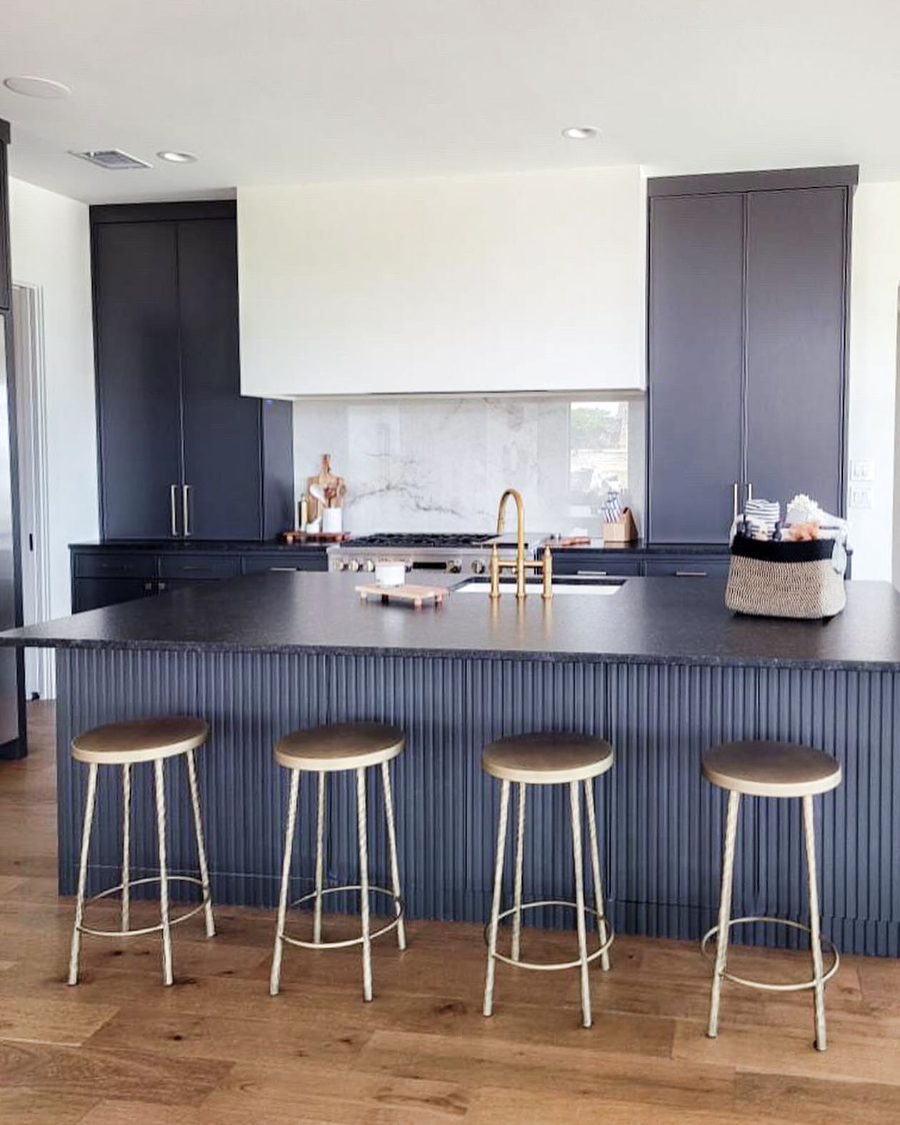 4. Sleek Monochrome Cabinets with Geometric Tile Backsplash Accent